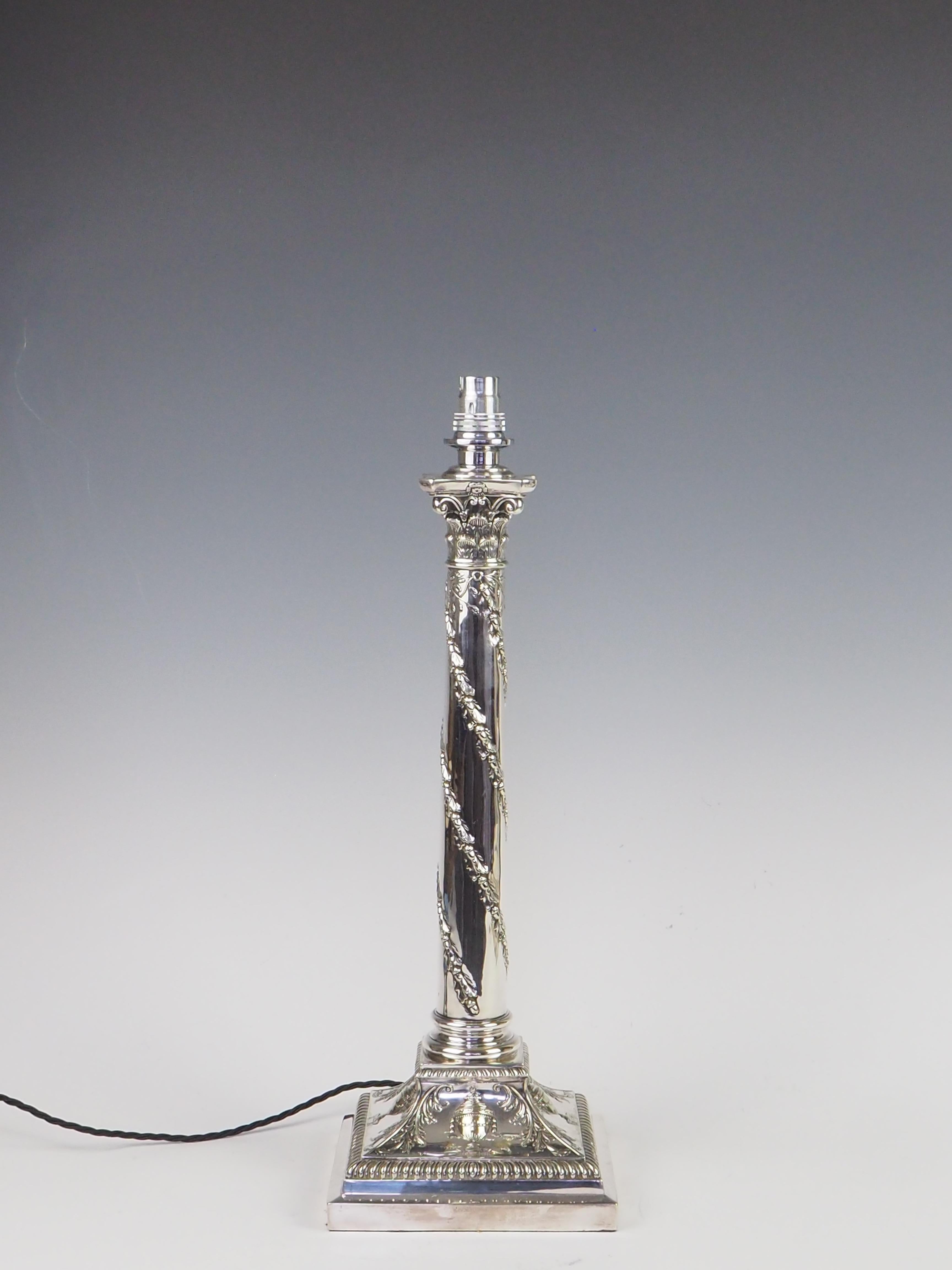 Antique Silver Plate Corinthian Column Table Lamp

Immerse yourself in the timeless allure of this exceptional Antique Silver Plate Corinthian Column Table Lamp, a piece that beautifully marries classical design with rich historical significance.