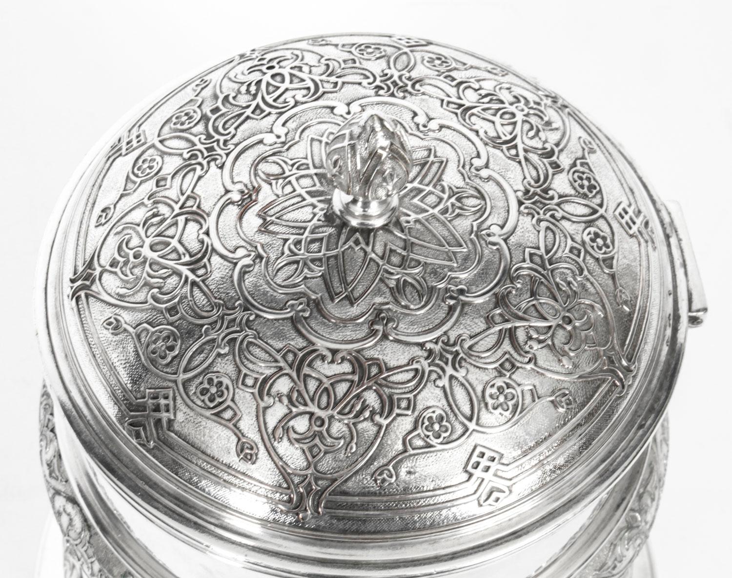 This is an exquisite silver plate biscuit box bearing the makers of the renowned silversmiths Elkington & Co, and bearing the Victorian Lozenge Registration mark that dates it to 1859.

The cylinder shaped box features a hinged domed top with