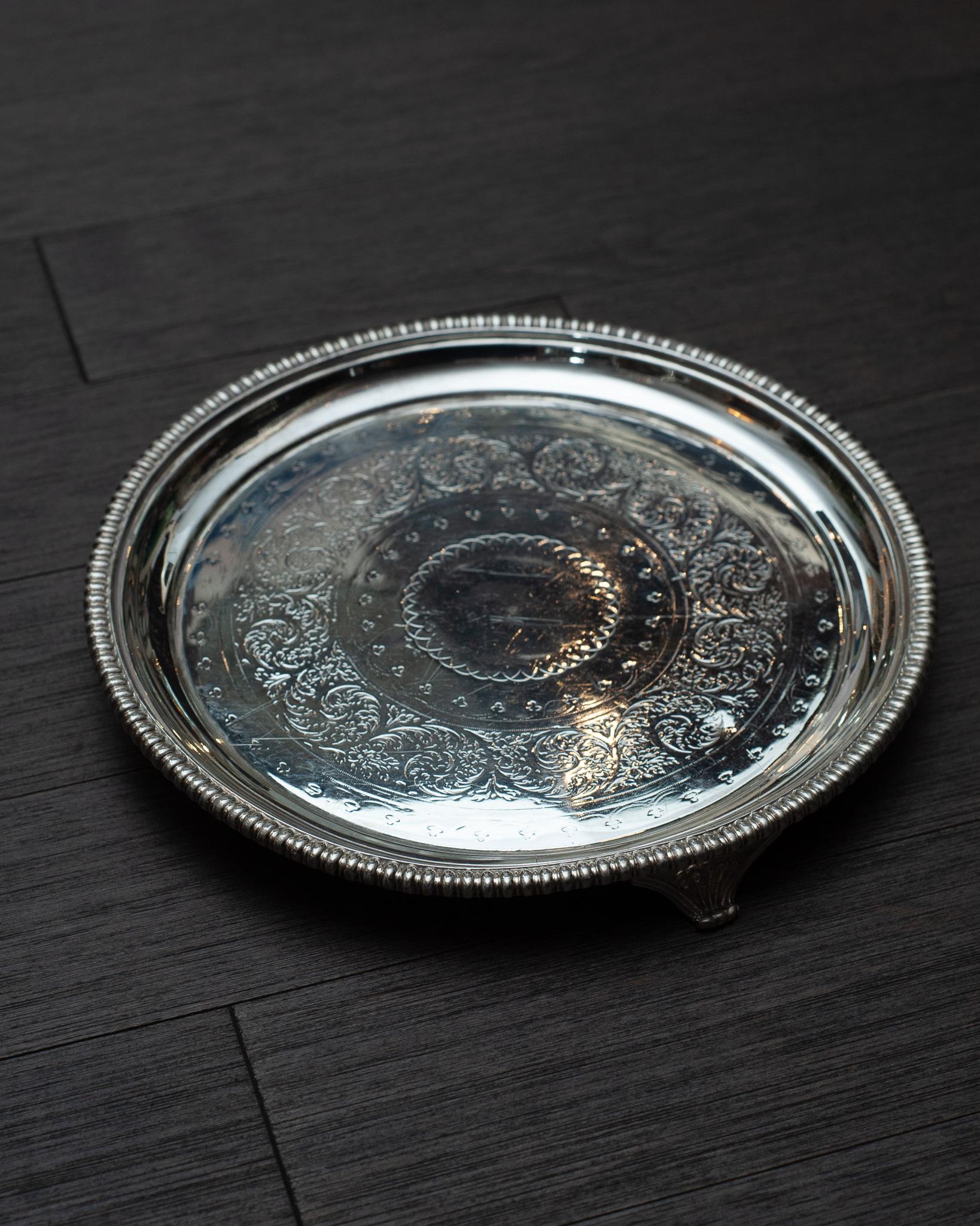 An antique silver plate round footed serving tray by Sorley Glasgow.