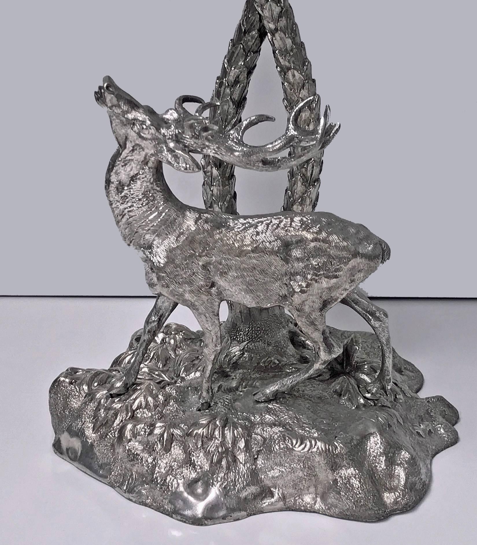 19th century Victorian Elkington style centrepiece, English, circa 1870. Silver-plated bronze cast in the form of a deer gazing up at palm trees. Measures: 17.00 (height) x 11.00 (breadth) x 7.00 (base) inches.