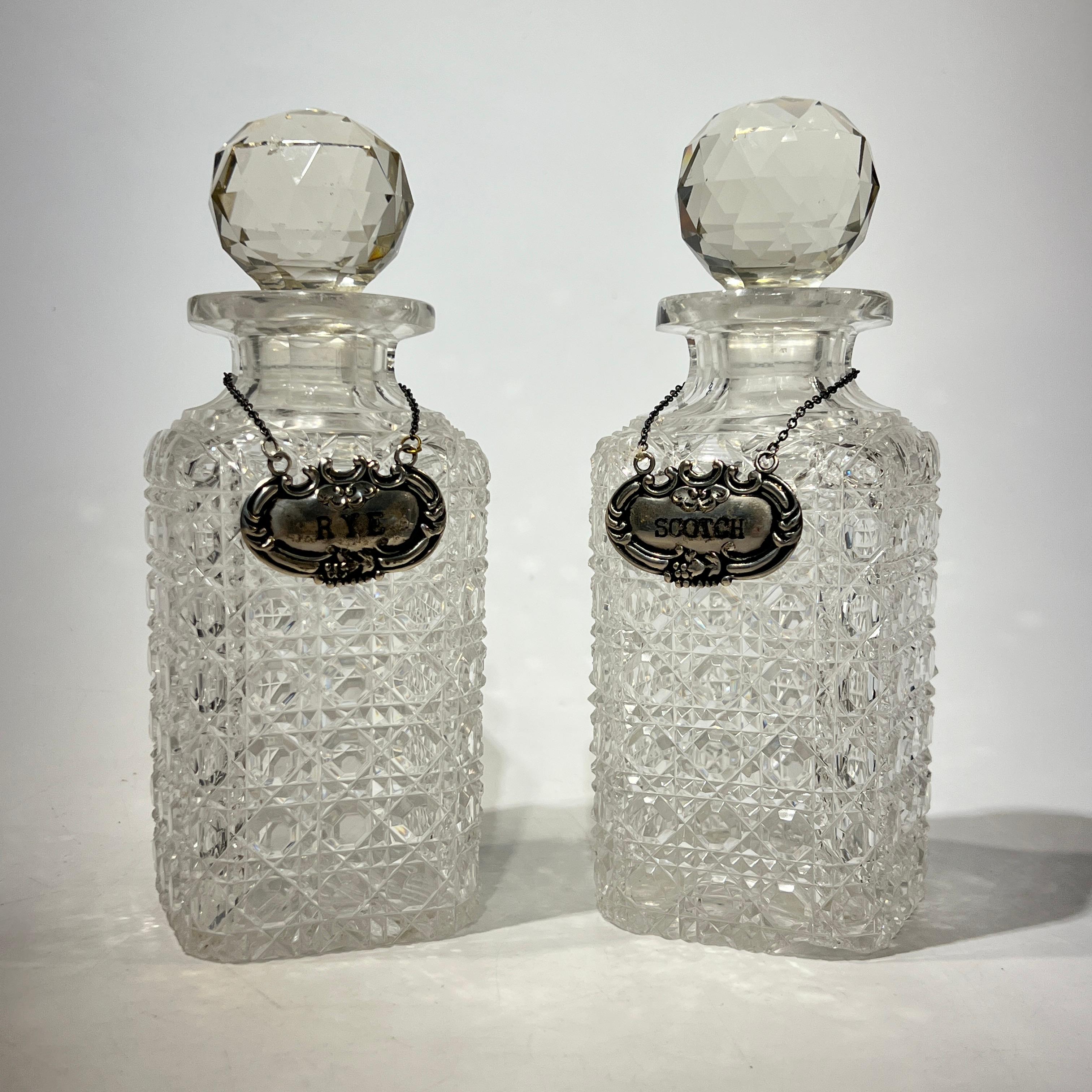 Antique silverplate tantalus with fine cut crystal decanters with sterling silver nameplates for rye and scotch.  Nameplates marked STERLING with W maker's mark.  