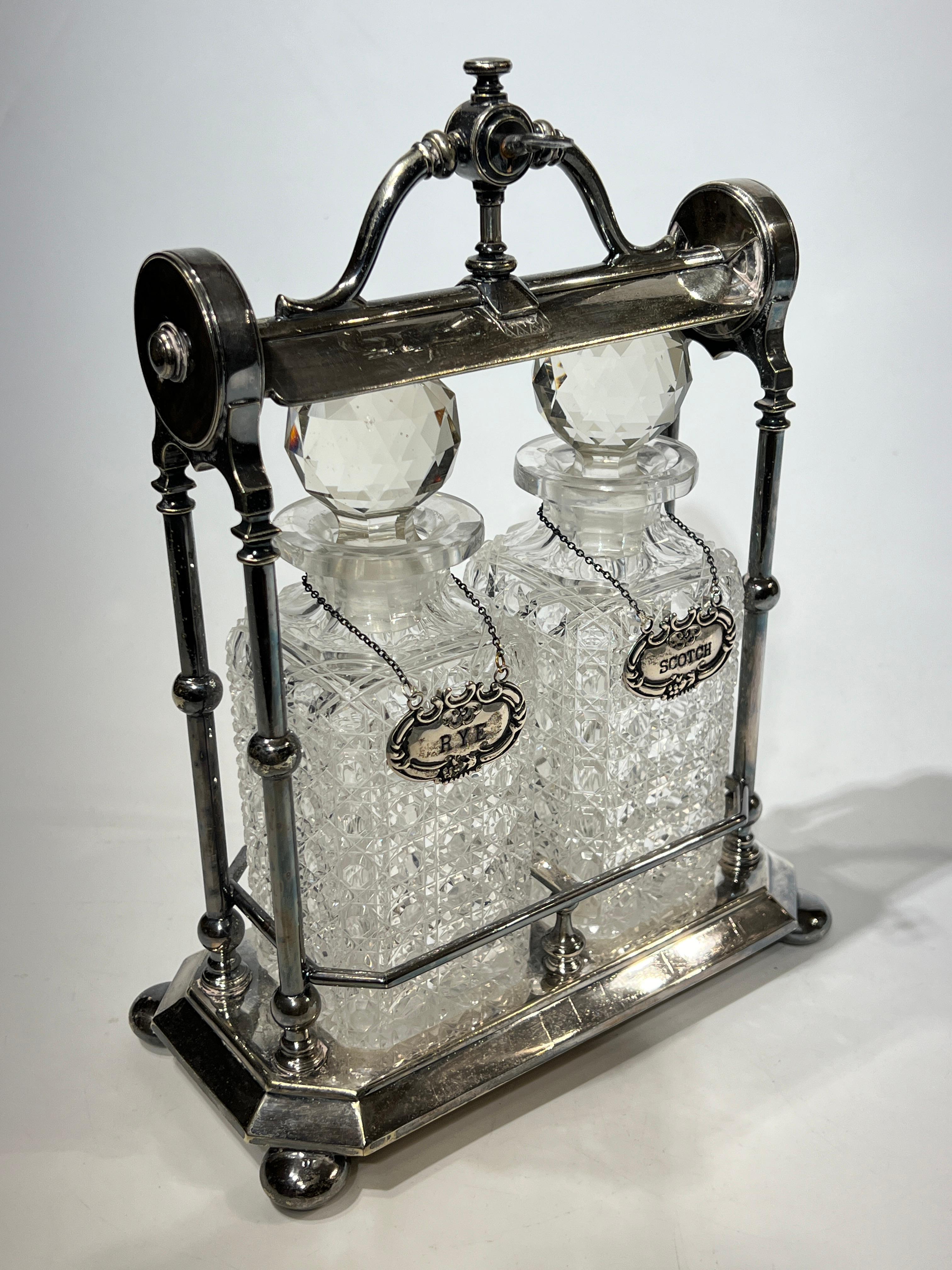 Antique Silver Plate Tantalus with Scotch and Rye Cut Glass Decanters In Good Condition In New York, NY