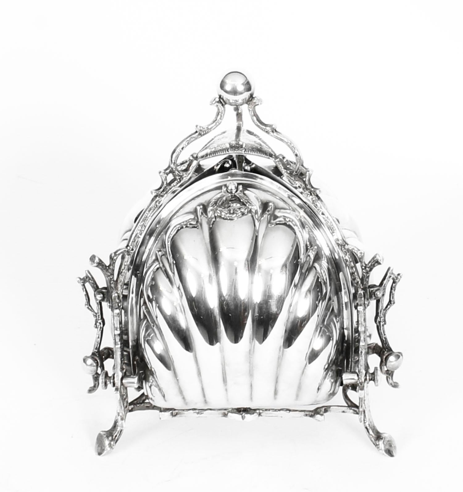 This is a beautiful antique Victorian triple clam shell shaped silver plated biscuit box stamped WA for W. Allan of Sheffield England, circa 1870 in date.

The scalloped biscuit box features a rounded triangular pyramid scalloped shell shaped body
