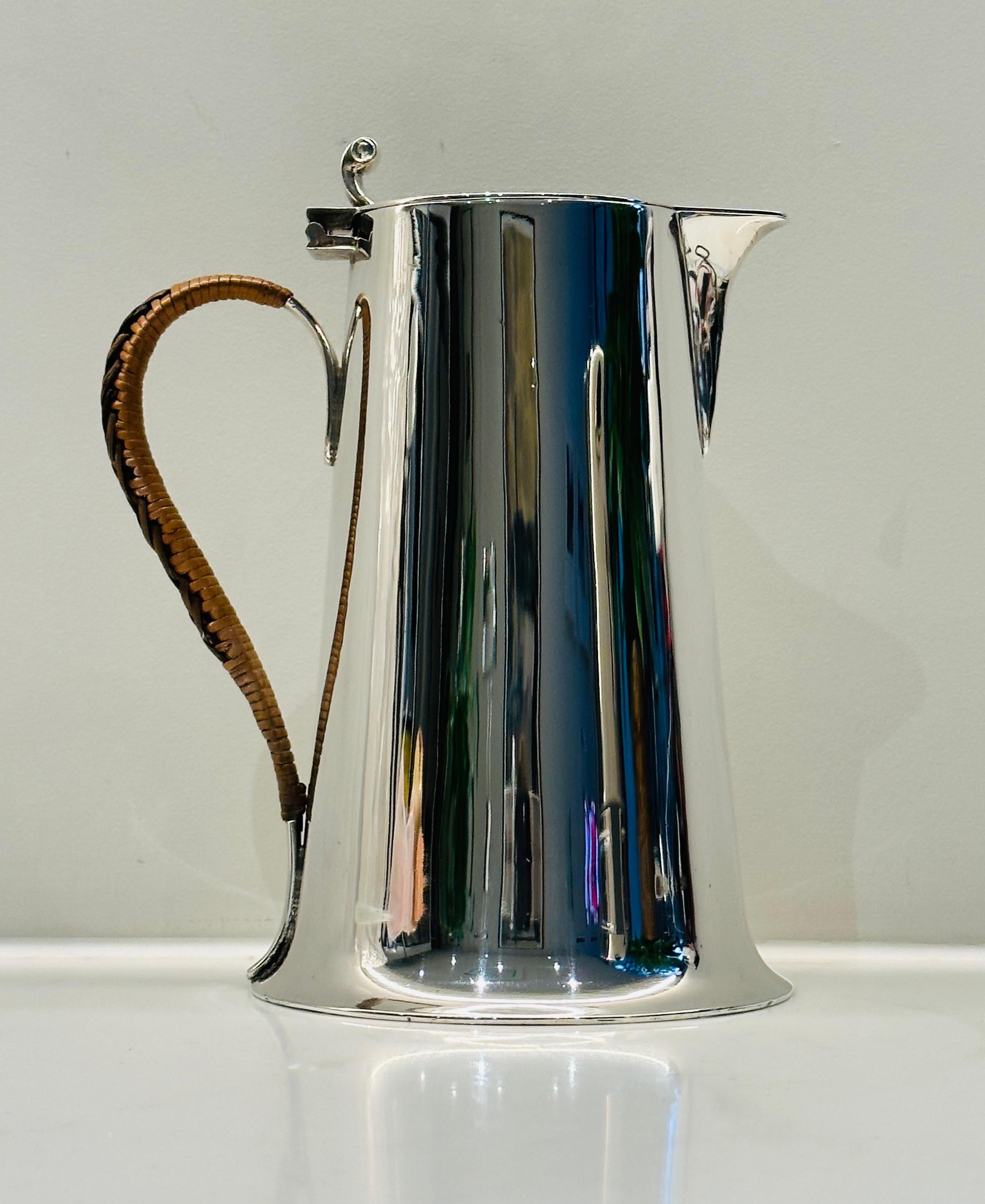 An antique 1920s silver-plated milk jug from the Arts and Crafts era with a rattan two-toned brown looped handle.
Hallmarked: CG & Co.  Silver Plated.
In good vintage condition.  I have detailed in the images a scratch on one side.
 
Dimensions:  H: