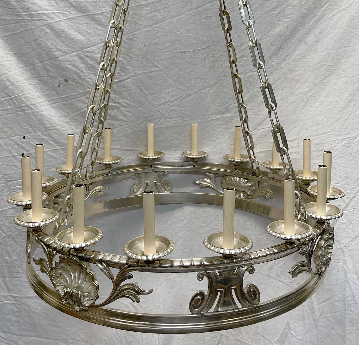 A circa 1900's English silver plated 12-light chandelier with foliage and shell motif.

Measurements:
Height:48