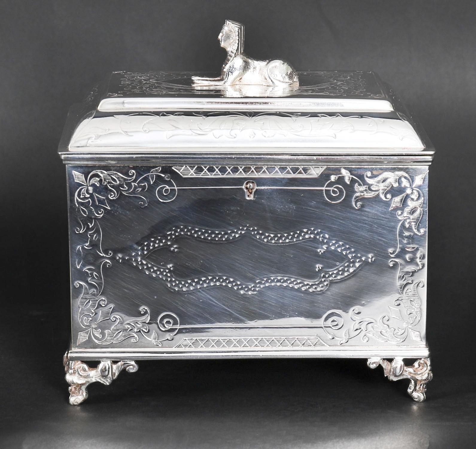Il s'agit d'une très belle boîte à thé ancienne Empire Revival en métal argenté, datant d'environ 1860.

Le caddy à couvercle rectangulaire présente une décoration gravée exquise et est surmonté d'un Sphynx décoratif.

Ajoutez une touche d'élégance