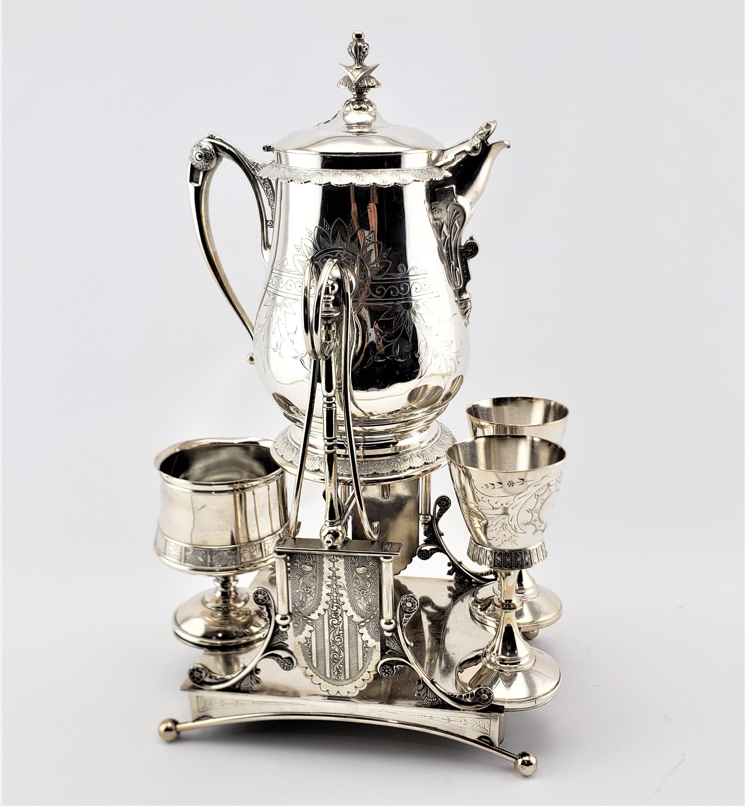 This antique and silver plated tipping ice water or lemonade stand was made by Simpson, Hall, Miller & Co. in approximately 1900 in the period Edwardian style. The set is composed of a sturdy silver plated stand, a large tipping pot, two silver