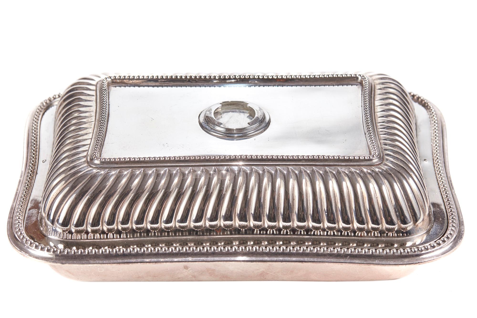 Offered for sale is this 19th century antique silver plated entree dish which has a lovely reeded lid and shaped handle. It is in perfect condition.