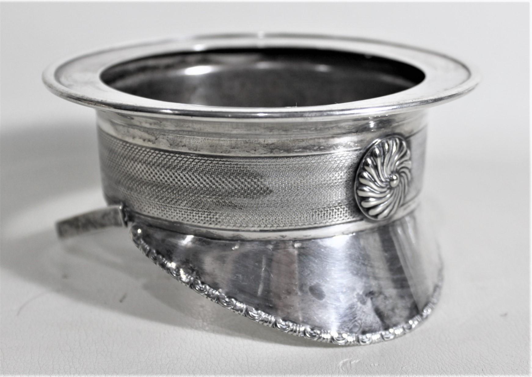 This very detailed and unique silver plated hat stand is hallmarked by an unknown maker, but presumed to have been made in England in approximately 1910 in the period style. This hat is done in a silver plated metal and is an extremely realistically