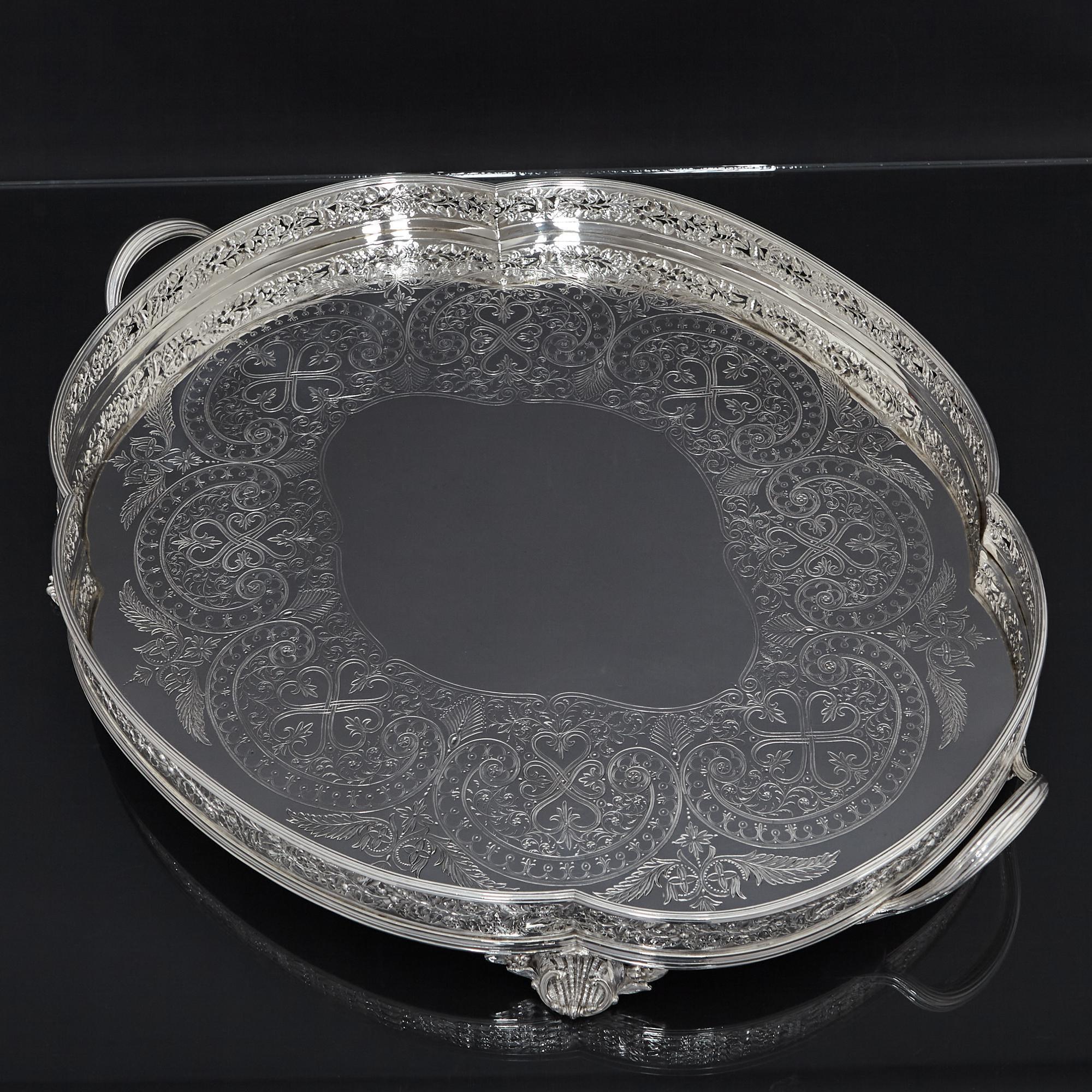 Large oval antique silver-plated gallery tray The surface of the tray is beautifully hand engraved with sections of quadriform scolls, tendrils of foliage, blossoms, bellflowers and flower heads. The open-work galley depicts finely detailed floral