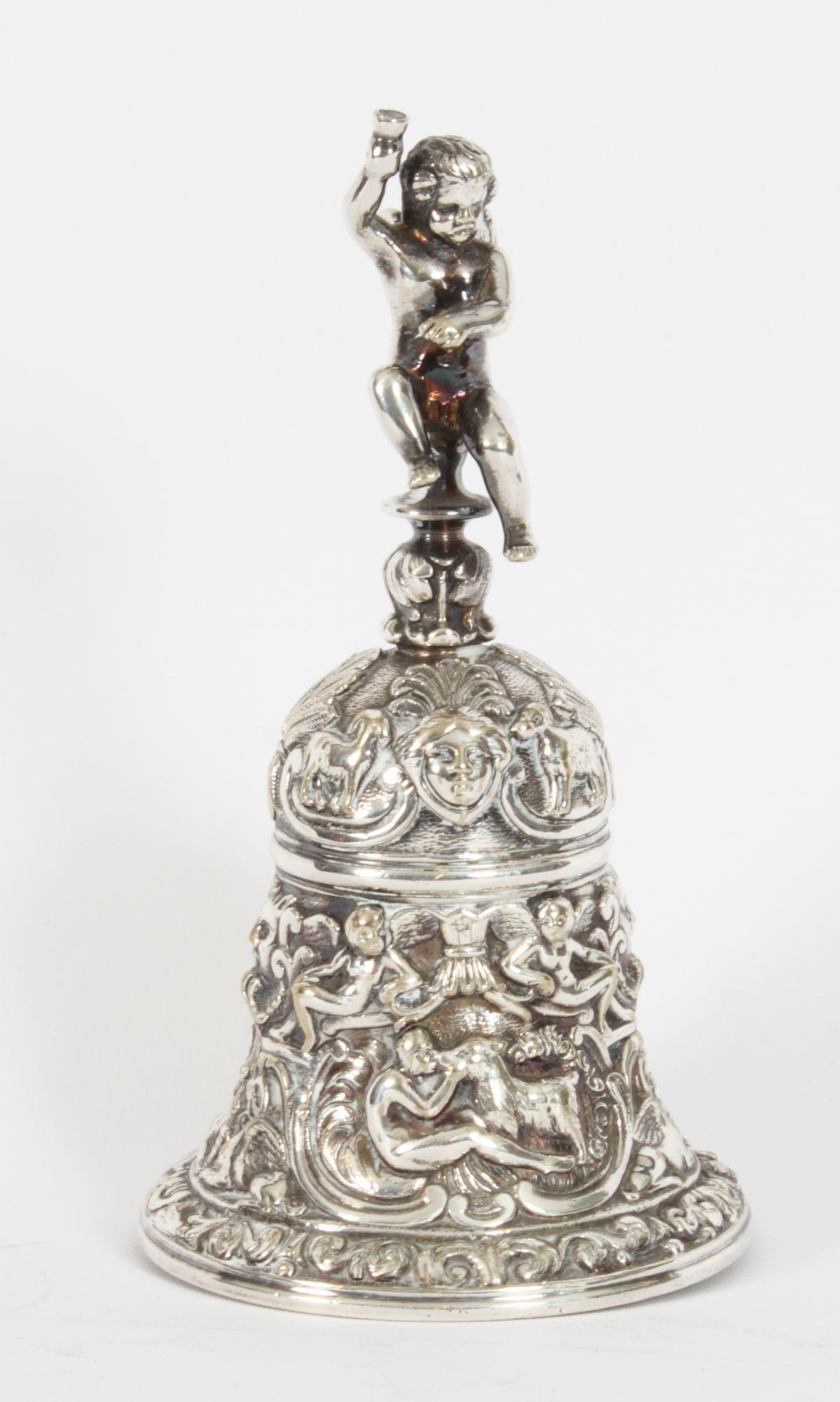 Antique silver plated Renaissance Revival Hand Bell by Elkington, late 19th century in date.
 
The heavy cast bell features the Renaissance profiles in ornately decorated panels to each side with a cupid handle to the top.
This bell is in truly