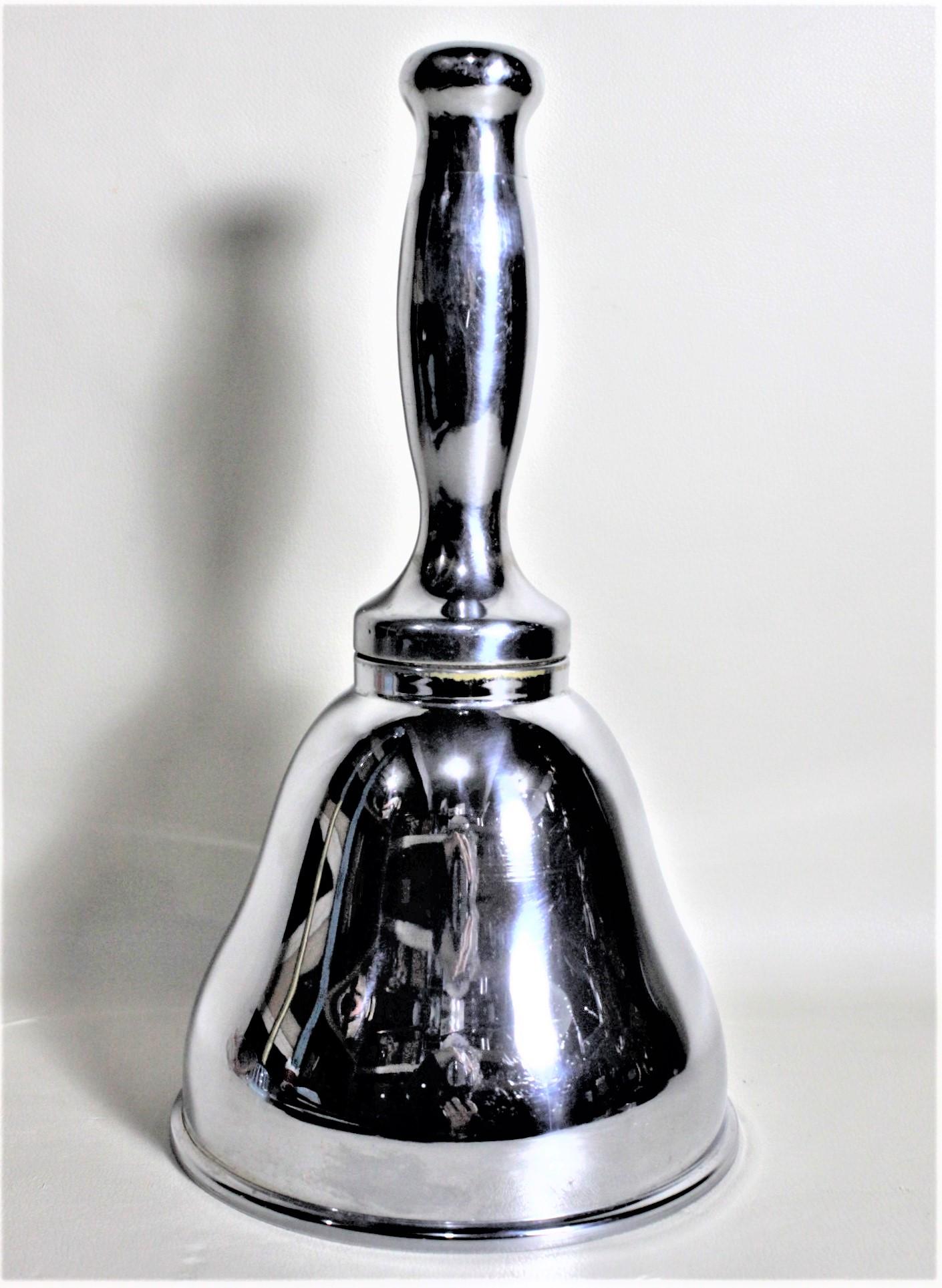 This silver plated cocktail Shaker is unsigned, but presumed to have been made in England in circa 1935 in the period Art Deco style. The shape of the Shaker is comparable to a hand held school bell or that used by a Town Crier. The Shaker is quite