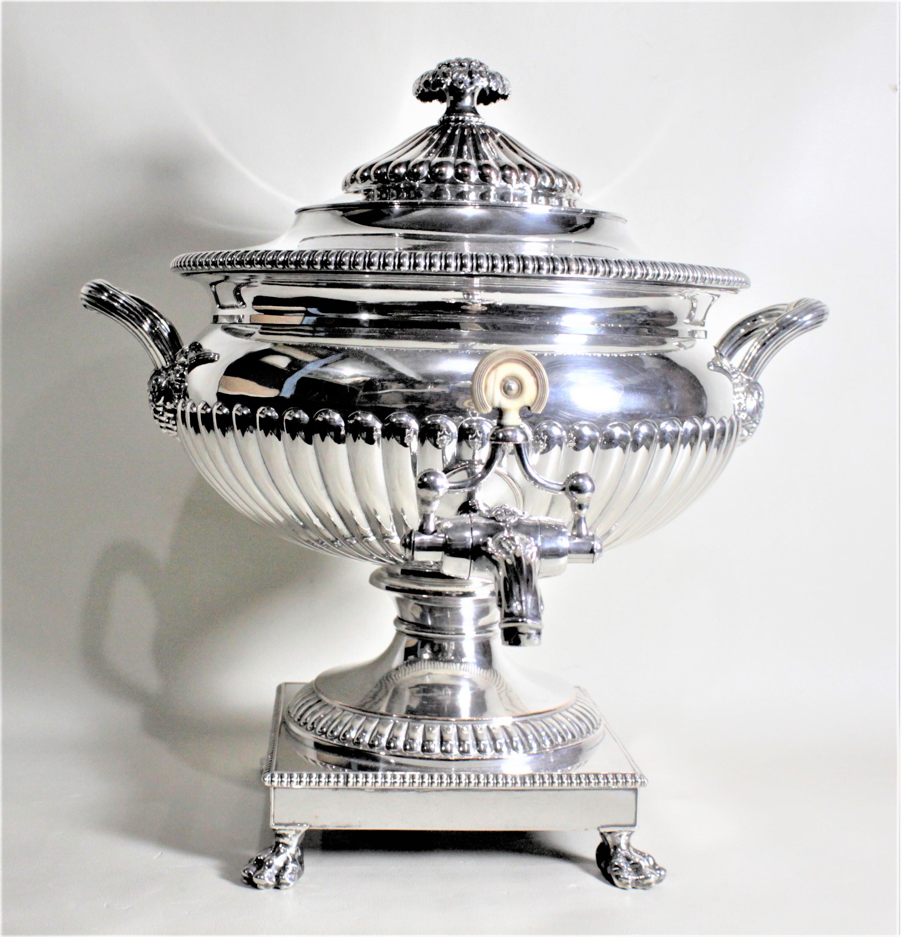 This antique silver plated hot water or coffee urn has no maker's marks but presumed to have been made in England in circa 1890 in the period Victorian style. The bowl of this urn is nicely decorated with a graduated ribbed design which is