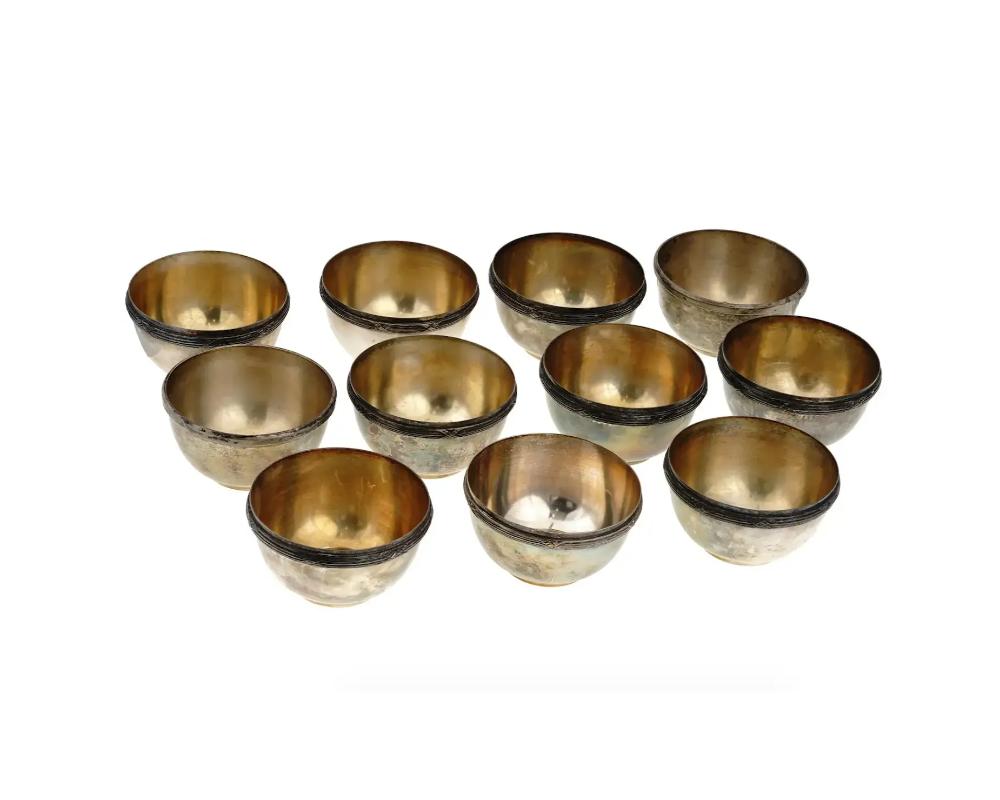A set of eleven antique silver plated ice cream bowls adorned with decorative rims with crossed ribbons. Marked. Circa the mid 19th century. Antique Silver Plated Bowls And Tableware Collectibles.

Dimensions: D 4 1/4 in. H 2 3/8 in. All