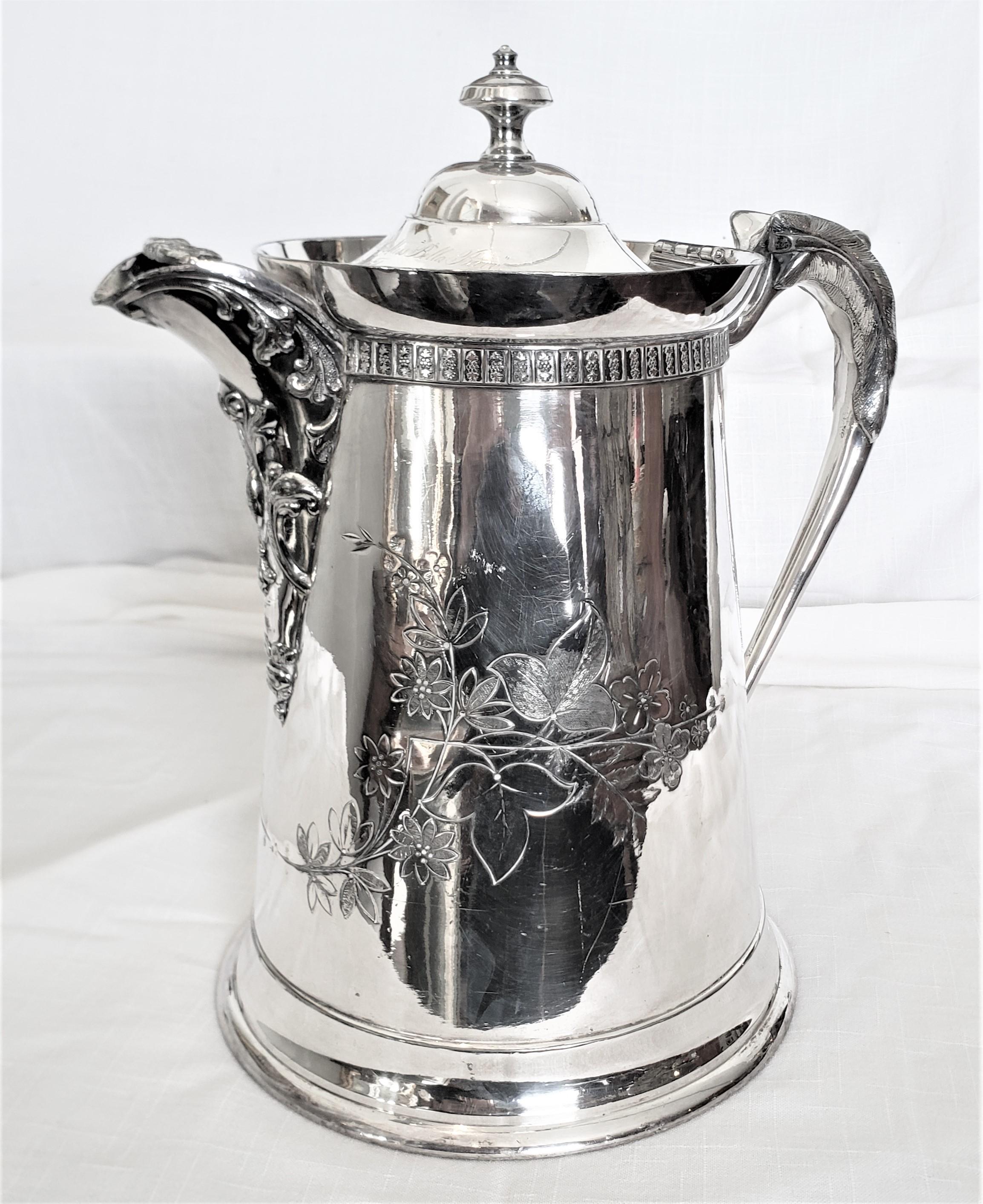This antique silver plated hot water pitcher shows no maker's signature, but is presumed to have originated from the United States and dating to approximately 1875 and done in a period Victorian style. This insulated pitcher was a presentation piece