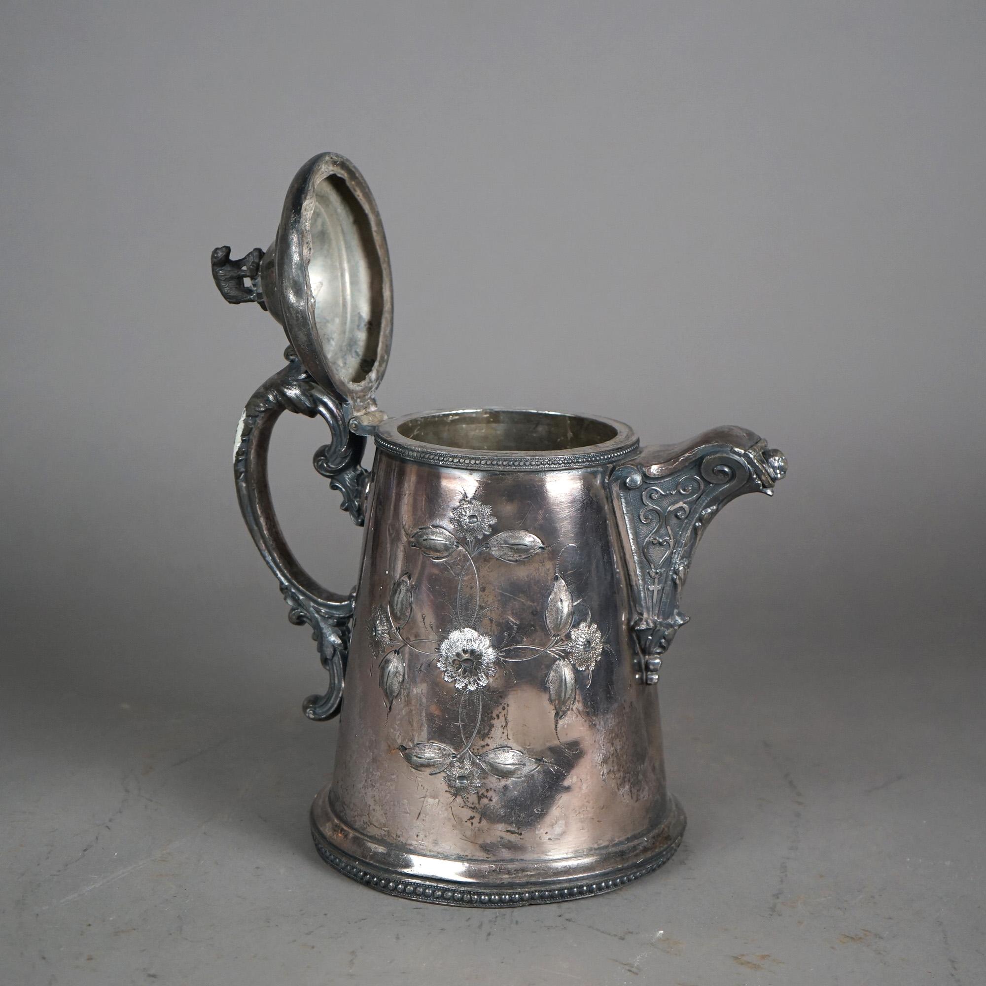 Antigua jarra de agua aislada plateada con grabado floral y remate de oso C1890

Medidas - 11,25