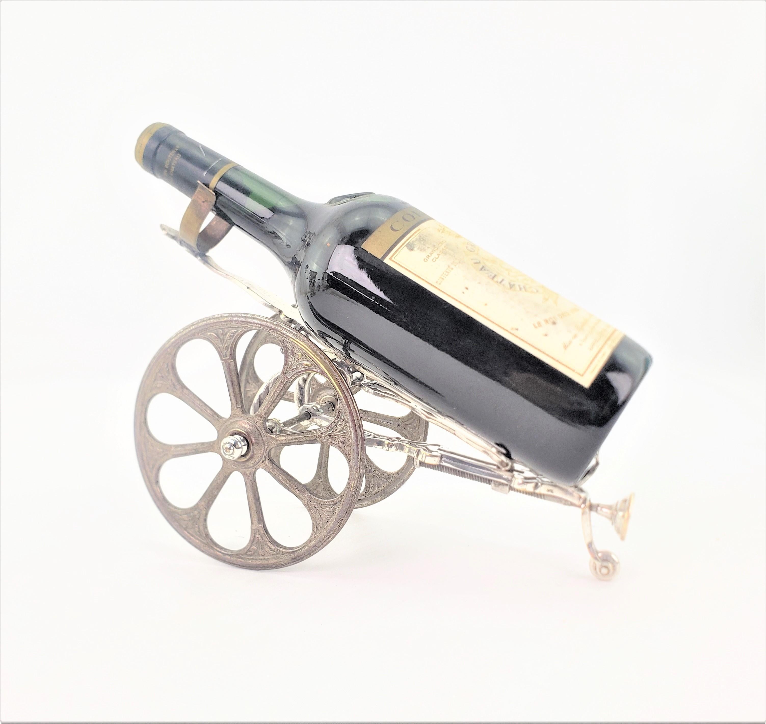 This well made mechanical gun carriage bottle trolley and pourer is unsigned, but presumed to have originated from England in approximately 1890 in a British Colonial style. The carriage is composed of machined metal which has been silver plated,