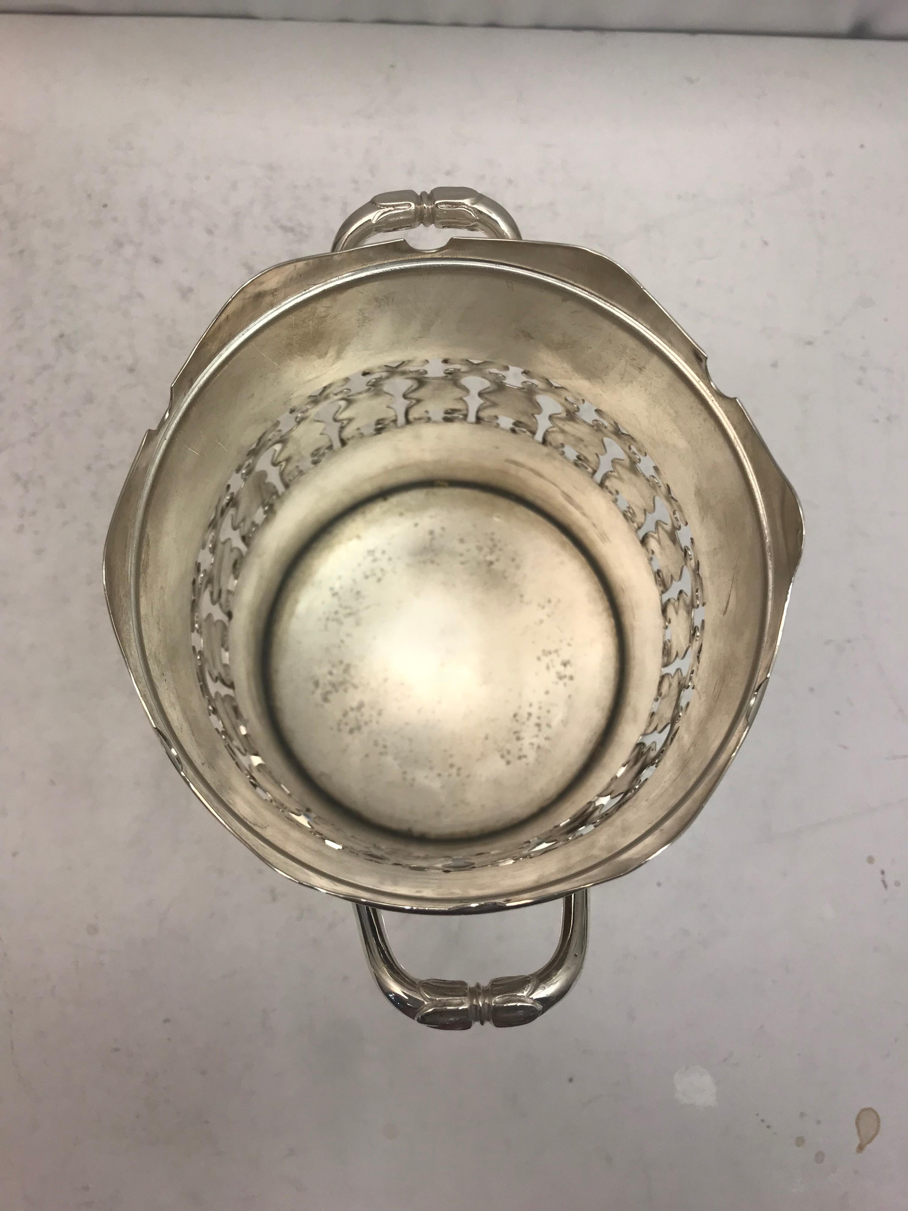 An two handled antique silver plate pierced wine bottle holder. Fully hallmarked. Made in 1900.
 