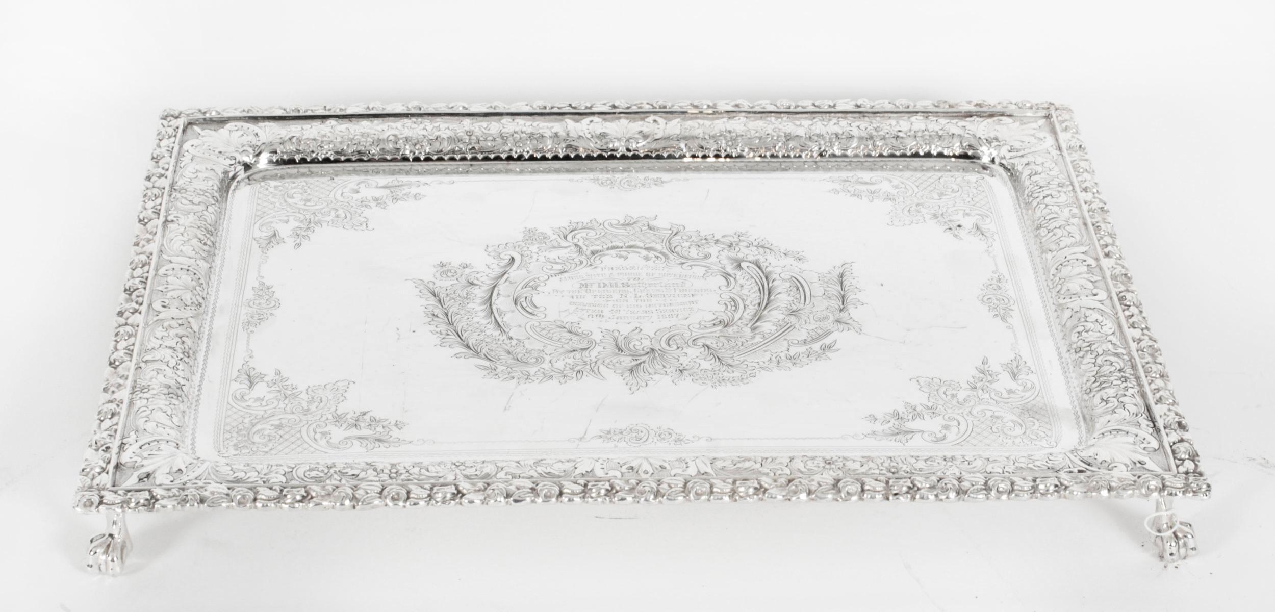 This is an exquisite Scotish antique old silver plate salver bearing the makers mark for Fenton Russel & Co C1880.
 
The rectangular salver features elegant highly decorated raised pie crust border surounding a hand chased foliate engraving and sits