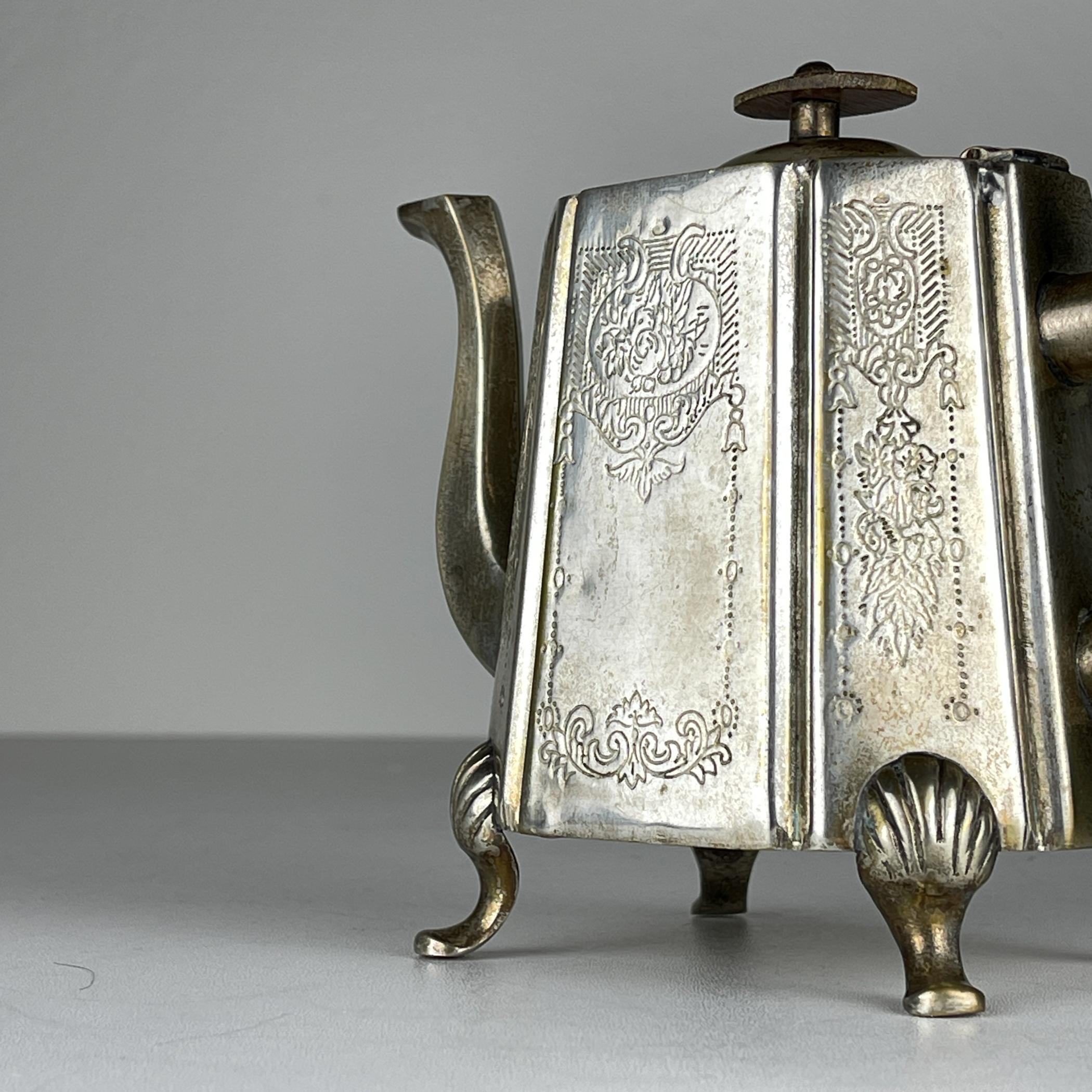 The antique teapot marked 