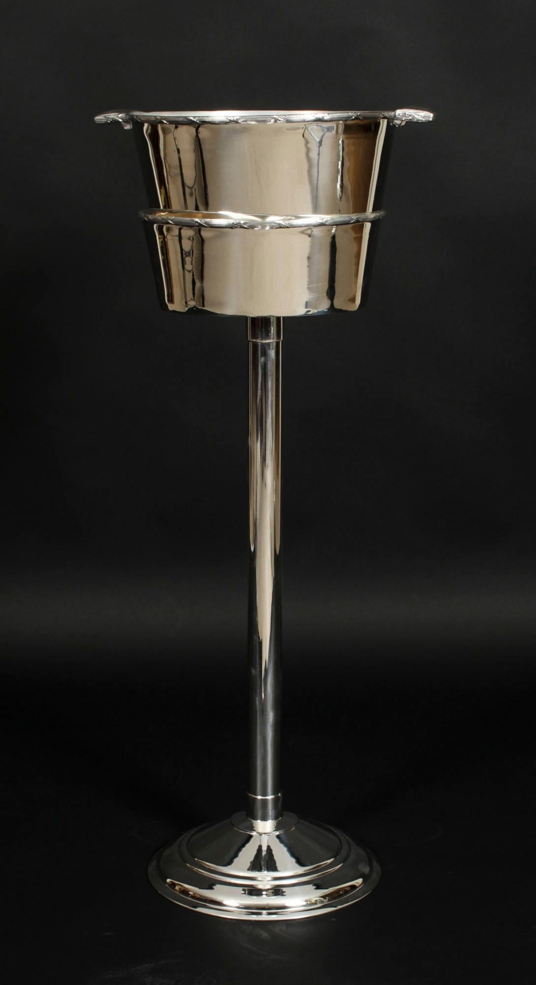 This is a fabulous silver plated champagne cooler on stand bearing the makers mark of the renowned silversmith,  Mappin & Webb, circa 1900 in date.

It is of beautiful design that is elegant and contemporary at the same time.

The simple but classic