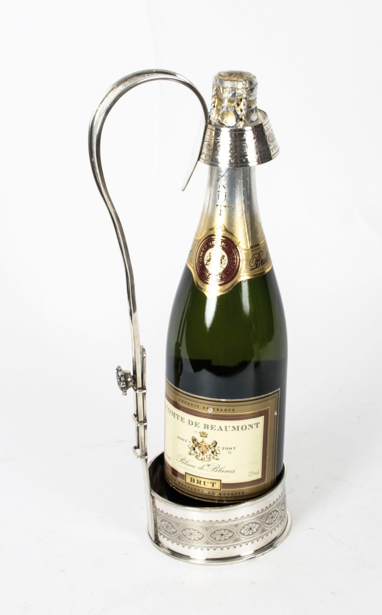 A very good quality late Victorian silver plated wine or Champagne pourer by Ekinngton & Co, circa 1880 in date.

It features an extendable handle and butterfly screw locking mechanism.
The scroll handle leads down to a circular gallery base and