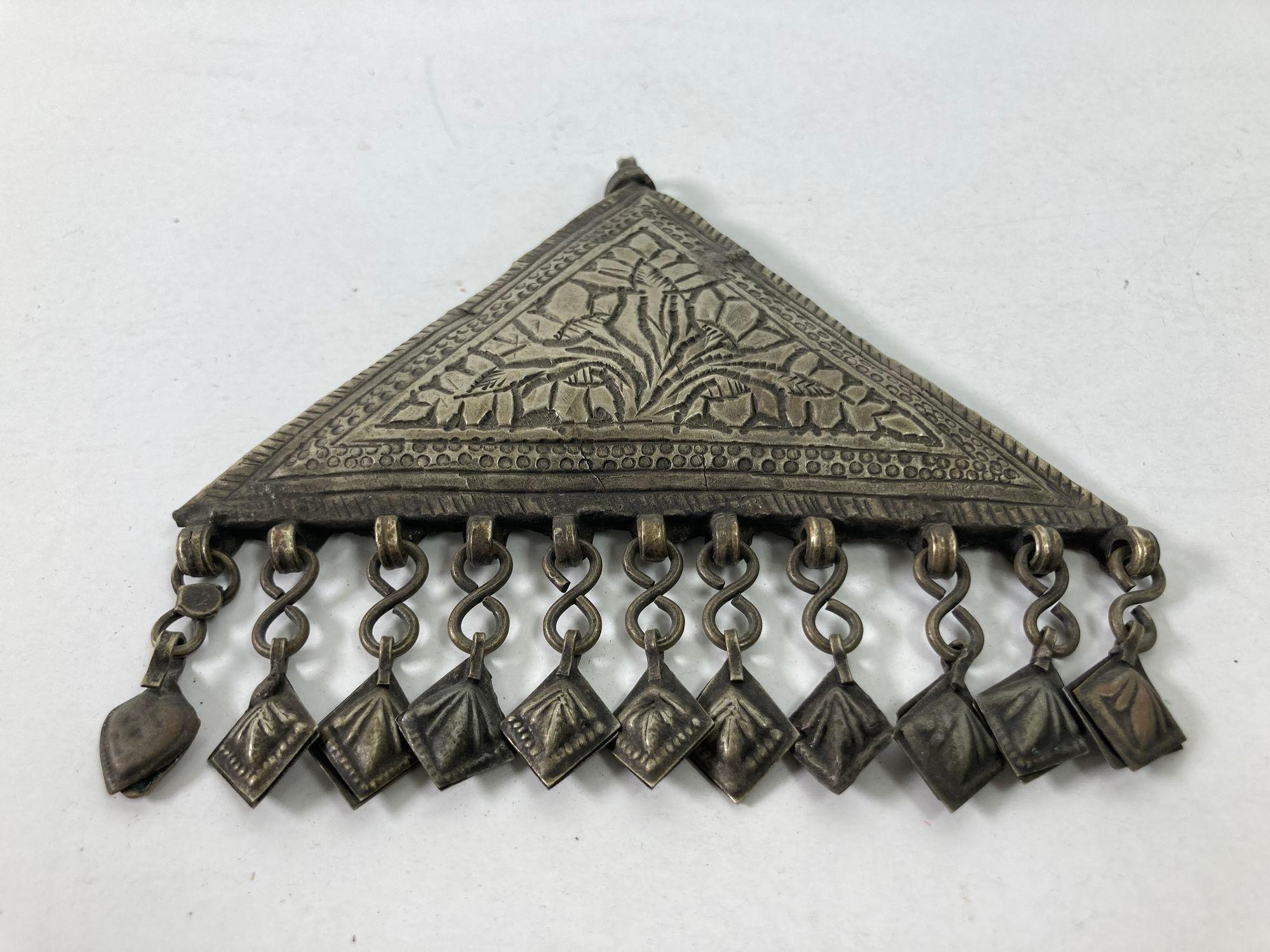 Boîte à talisman islamique en argent repoussé.
Grand pendentif talisman tribal ethnique berbère.
De forme triangulaire, ce talisman miniature en argent repoussé devait contenir certains versets de l'Apocalypse coranique, considérés comme ayant des