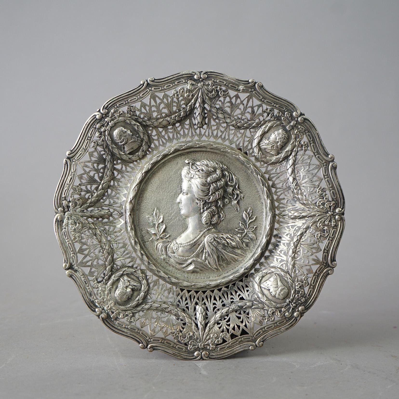 An English silver portrait tray offers silver construction with central portrait and reticulated rim having garland and additional portrait reserves, hallmarked, 19th century

Measures - 9.5