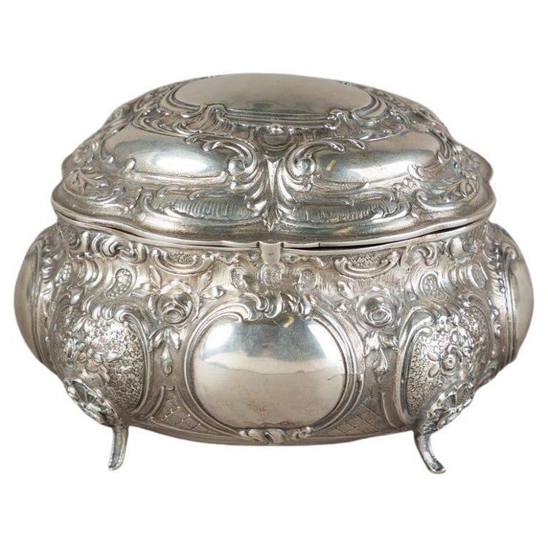 Antique silver box or Decorative sugar bowl, pressed, cast and chased, gold gilding on the inside. Oval, domed body on short, curved feet with hinged, vaulted lid. All-encompassing C-curves in relief, latticework, rocailles, tendrils of flowers and