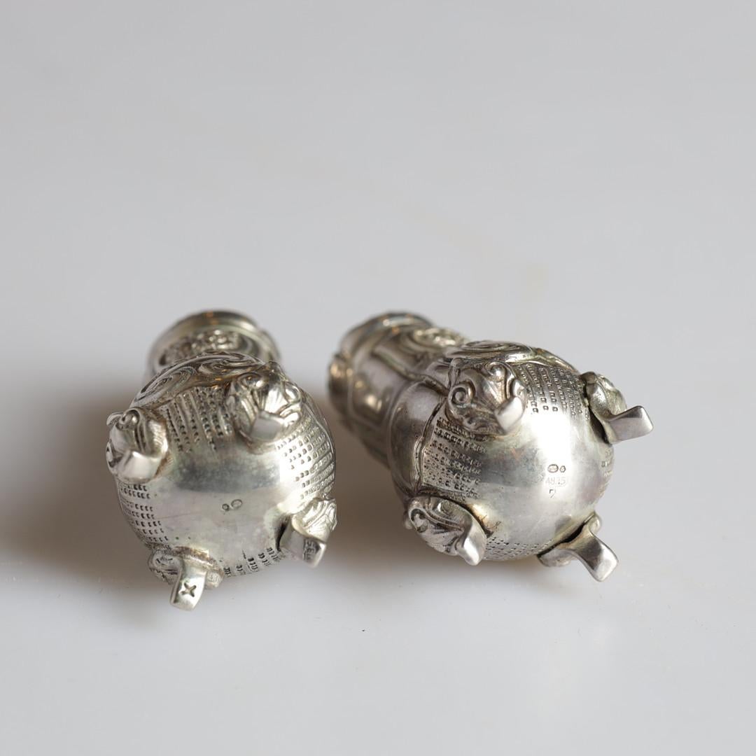 Antique valuable silver salt and pepper shaker or Decorative tableware pressed, cast and chased, gold gilding on the inside. Oval, domed body on short, curve  All-encompassing C-curves in relief, latticework, rocailles, tendrils of flowers and