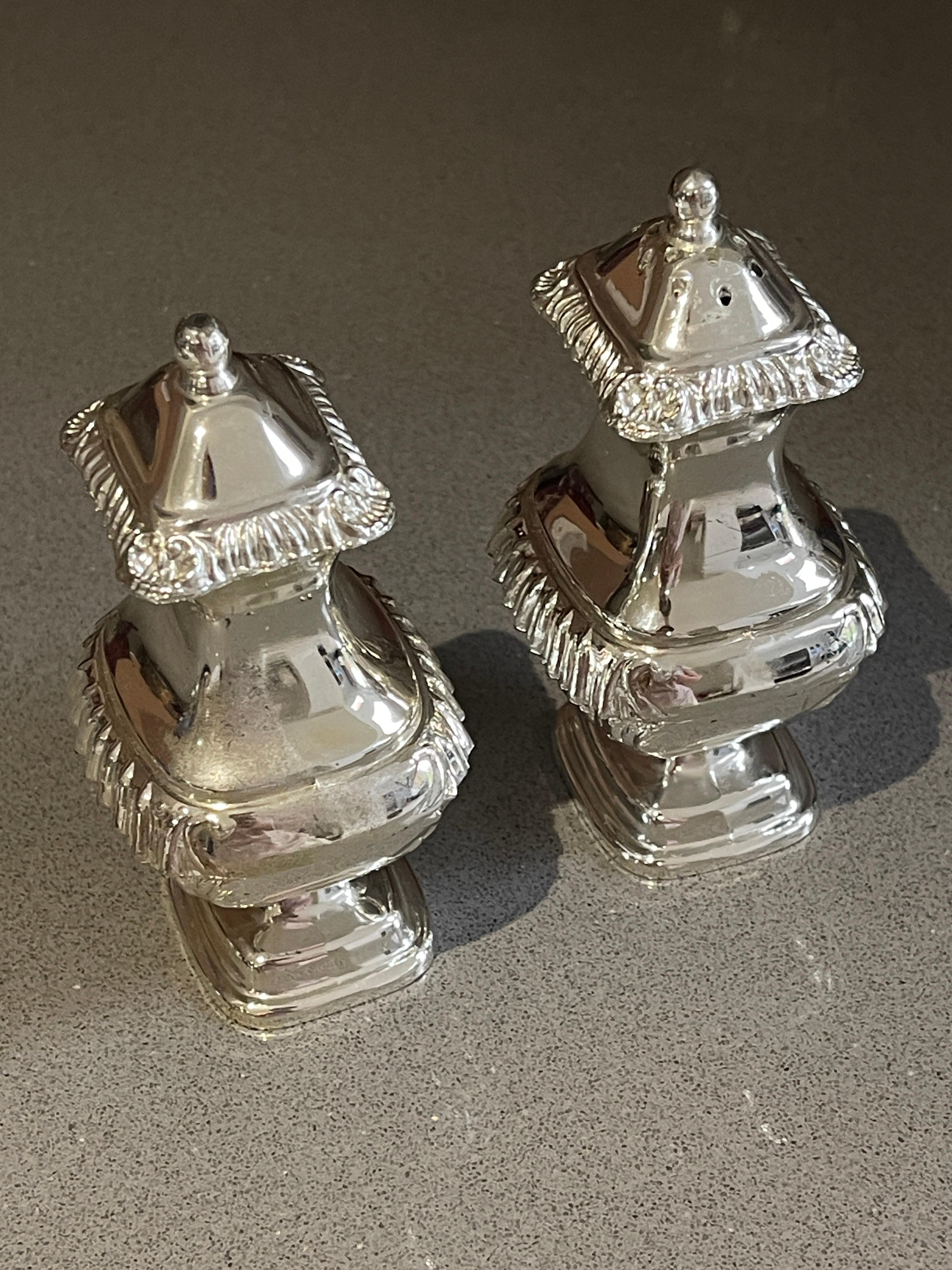 Antique valuable silver salt and pepper shaker or Decorative tableware pressed, cast and chased. Oval, domed body on short, curve  All-encompassing C-curves in relief, latticework, rocailles, tendrils of flowers and matching cartouches.
Highly