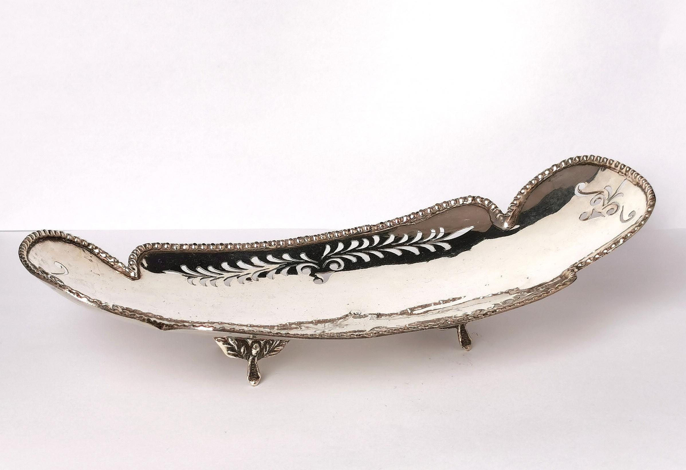 An attractive antique early 20th century bread or sweetmeat dish.

It is made from 800 silver and has an elongated shape standing raised on 4 feet with repousse detailing.

The dish has a beaded rim and Pierced decoration making it a very