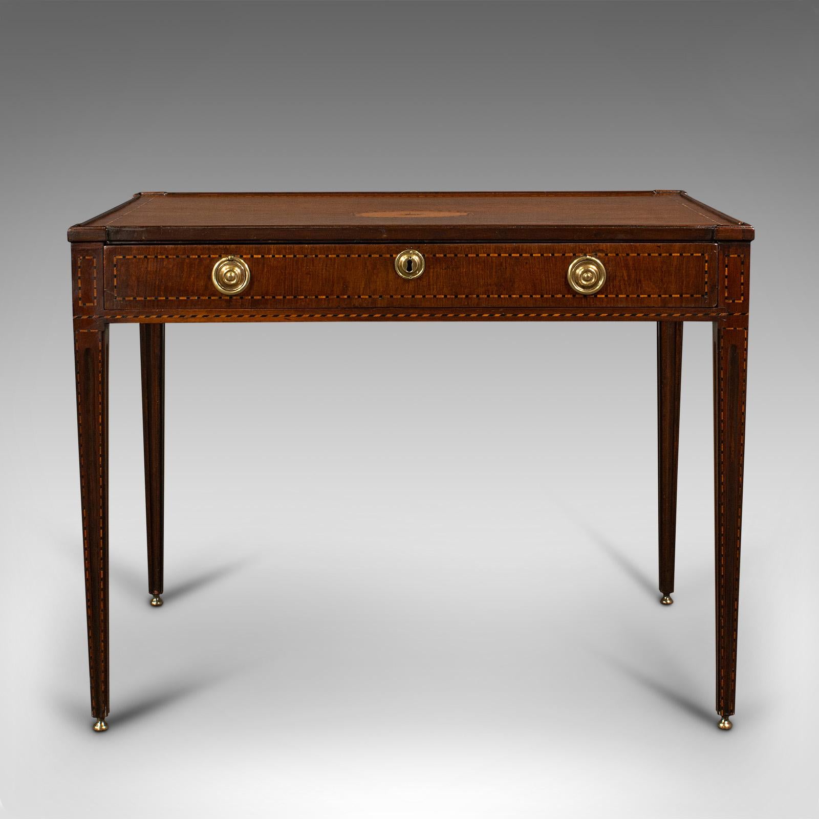 This is an antique silver table. An English, rosewood inlaid display or writing table, dating to the late Georgian period, circa 1780.

Delightfully presented silver display table from the time of George III
Displaying a desirable aged patina