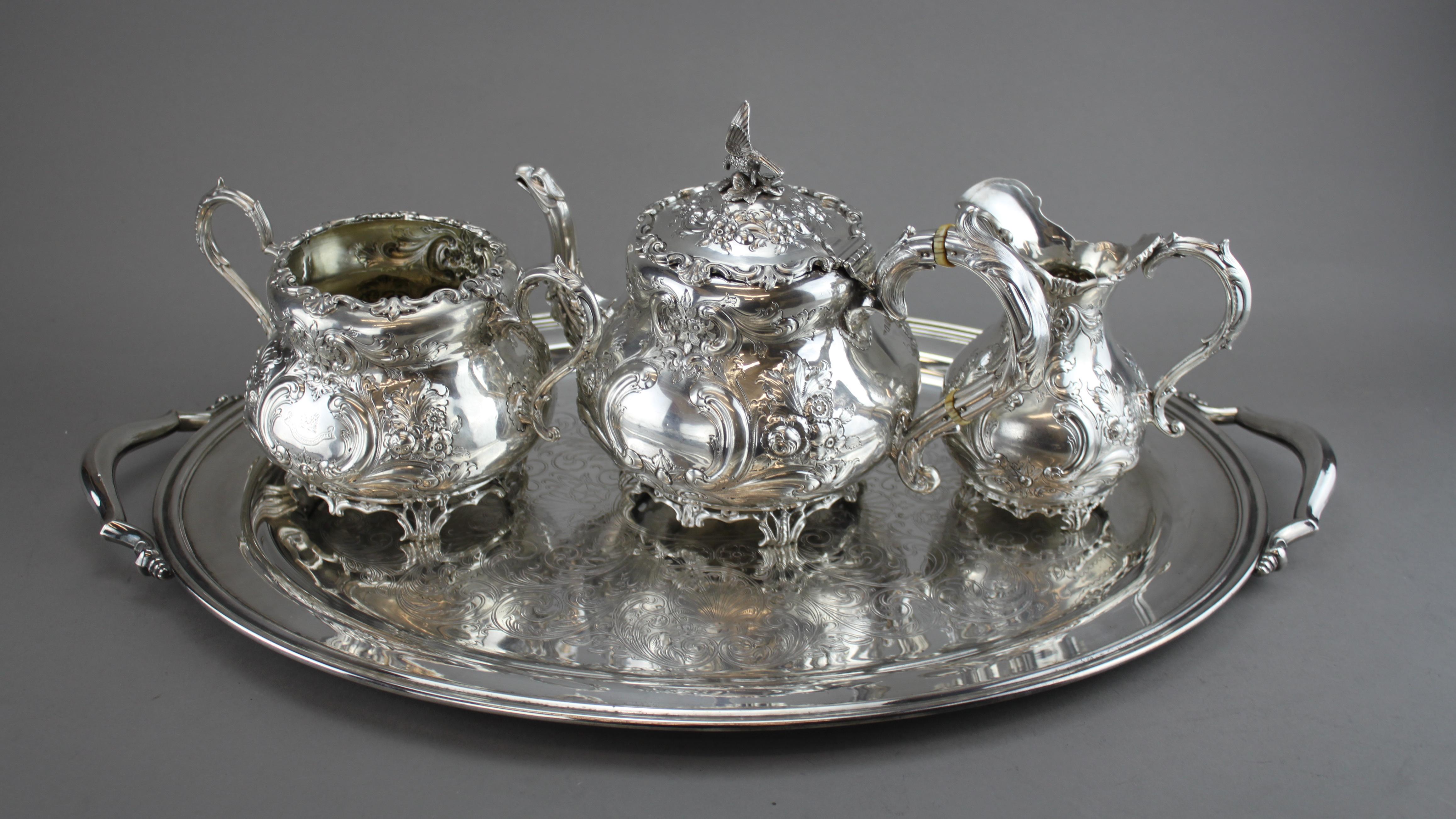 Antique sterling silver elaborately engraved tea service set.
Maker: Charles Lambe
Made in Dublin 1900
Fully hallmarked.

Dimensions - 
Teapot Size : 27 x 16.7 x 19.5 cm
Weight : 768 grams

Sugar Bowl Size: 23 x 14.5 x 14 cm
Weight: 462 grams

Cream