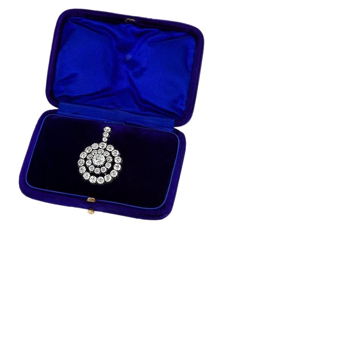 An Antique silver-topped gold pendant with a diamond-studded pendant loop featuring two rings of old European-cut diamonds surrounding one exceptional, significant center stone. The center diamond is approximately 2.35 carats, surrounded by 10 old