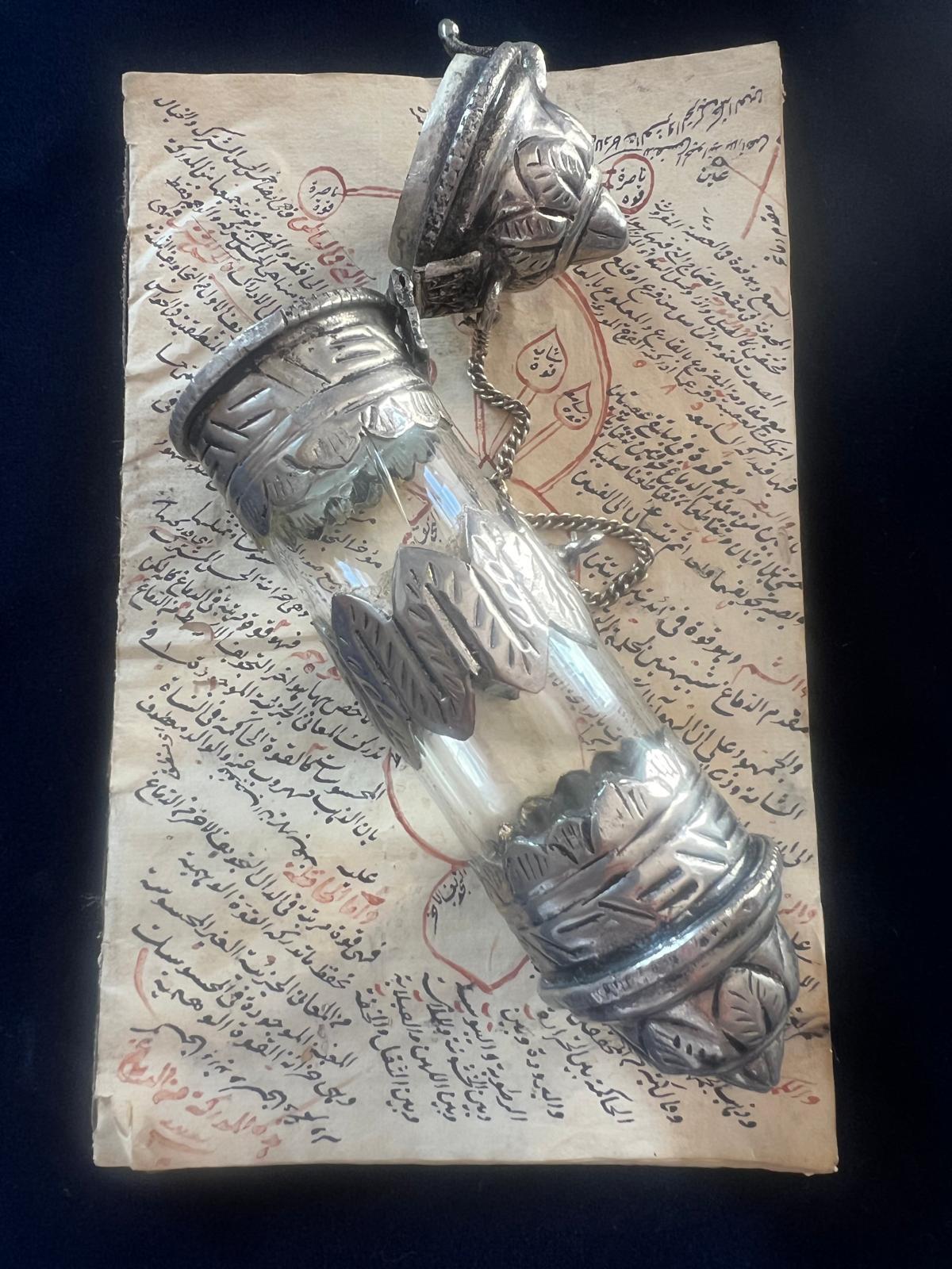 This is a beautiful and masterfully done silver oriental tube with hand written Quran excerpts parchment roll inside. The Tube has been hand crafted in 19th century and the scroll itself is originated from 18th century. The parchment roll is hand