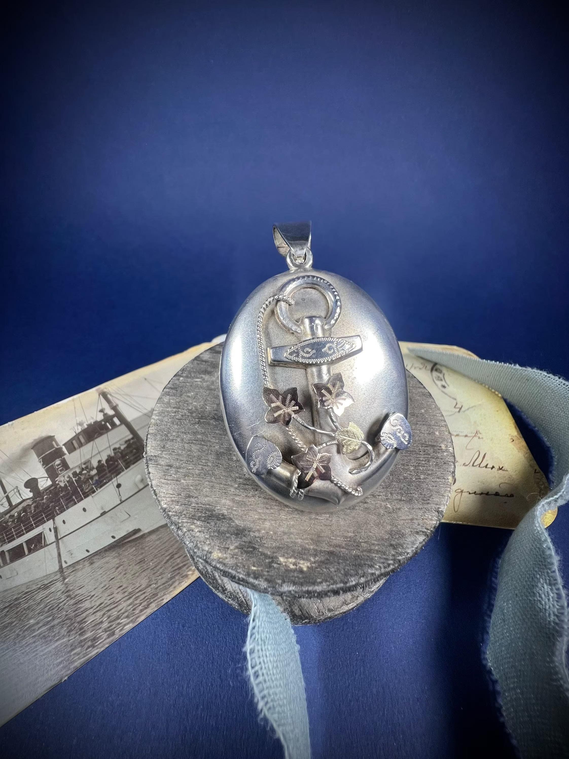 Antique Silver Locket 

Silver- Tested 

Circa 1880

Beautiful, Victorian silver locket. Fabulous sized oval shaped locket with symbols for Faith, Hope & Charity intwined with silver rope, yellow & rose gold Ivy leaves. 
The insides are intact & in