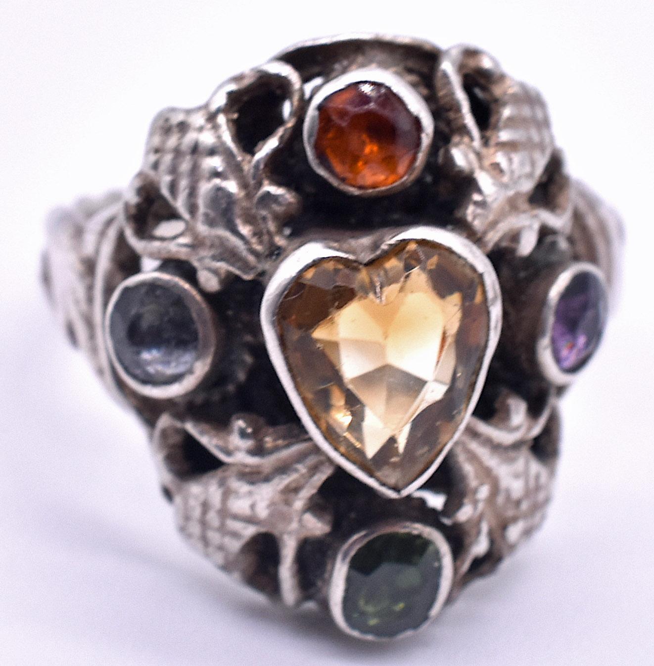 Unusual sterling silver Victorian ring with a diamond on one side and an amethyst on the other, and a cushion cut tourmaline, garnet, and citrine heart in the center. The ring is US size 6 1/4.