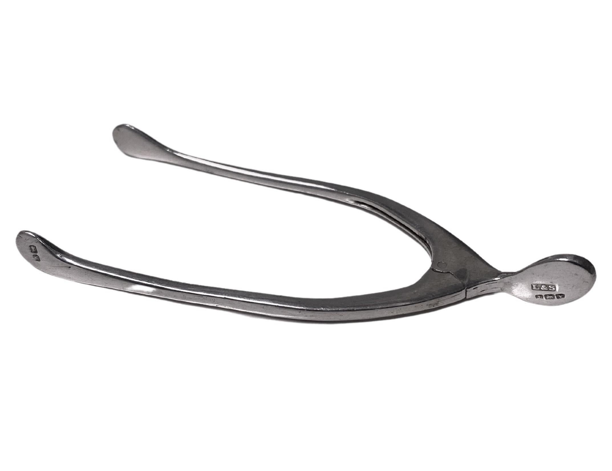 Antique Silver Wishbone Sugar Tongs Birmingham 1920 Levi and Salaman. Flexible integral spring wishbone tongs, plain design. Hallmarked on handle and tong. Length: 3.50 inches. Weight: 13.09 grams