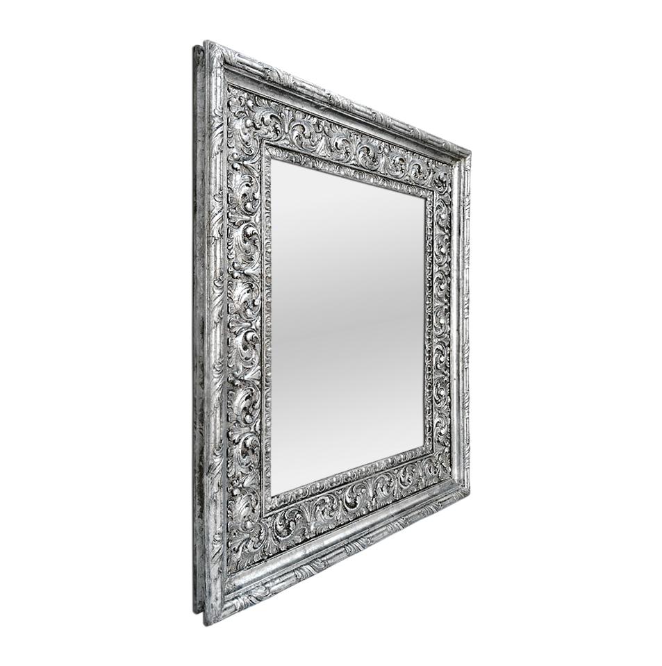 Antique silver wood mirror Baroque style, circa 1930. Decor with scrolls of foliage and fluting. Re-gilding to the patinated silvered leaf. Modern glass mirror. Antique frame width: 12 cm / 4.72 in. Antique wood back.