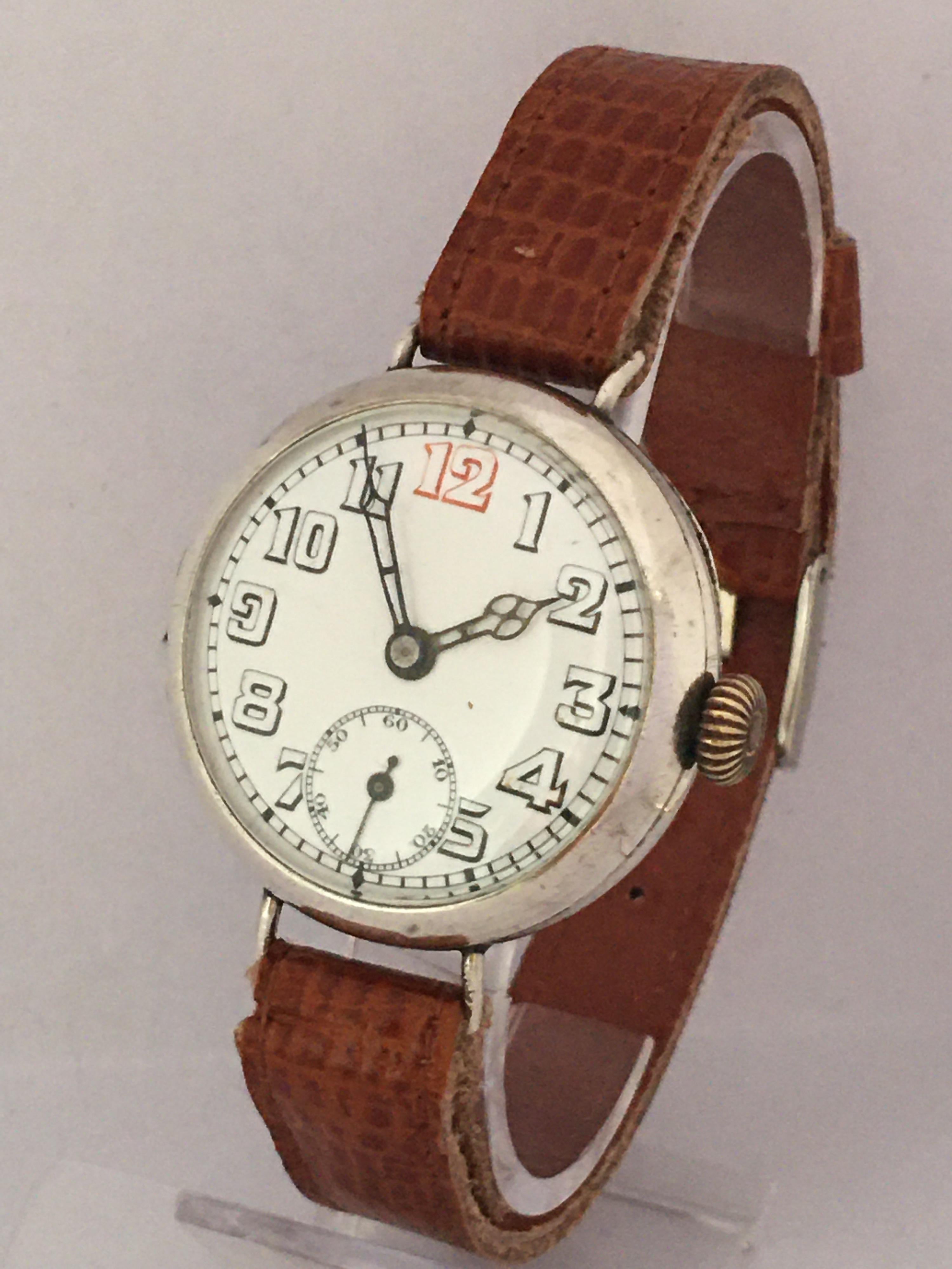 WWI period silver wire-lug gentleman's trench watch, import hallmarks London 1915, circular white enamel dial with Arabic numerals, red twelve, minute track and subsidiary seconds, cathedral hands, hinged case, modern tan leather strap,