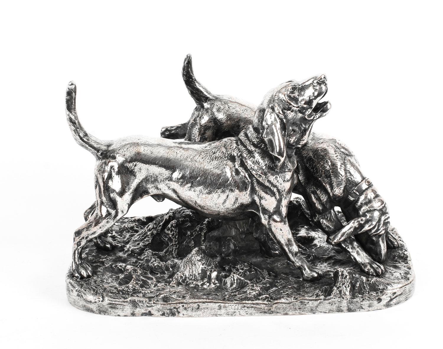 A fantastic English silver plated bronze centrepiece sculpture of a pair of hunting dogs, stamped with the name of the renowned silversmith Elkington, 19th century in date.

Skillfully cast in excellent detail, the sculpture features a pair of