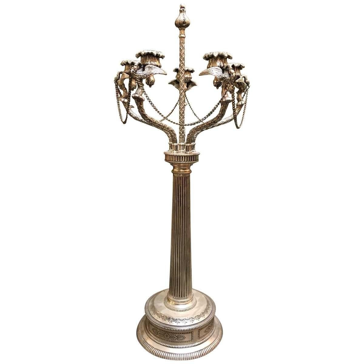 Neoclassical takes its roots from Greek and Roman discoveries in the eighteenth century with a style that is lush and elegant. Vintage six-light, thought to be pewter, elaborately designed candleholder.
Features tulip cups with avian adornments