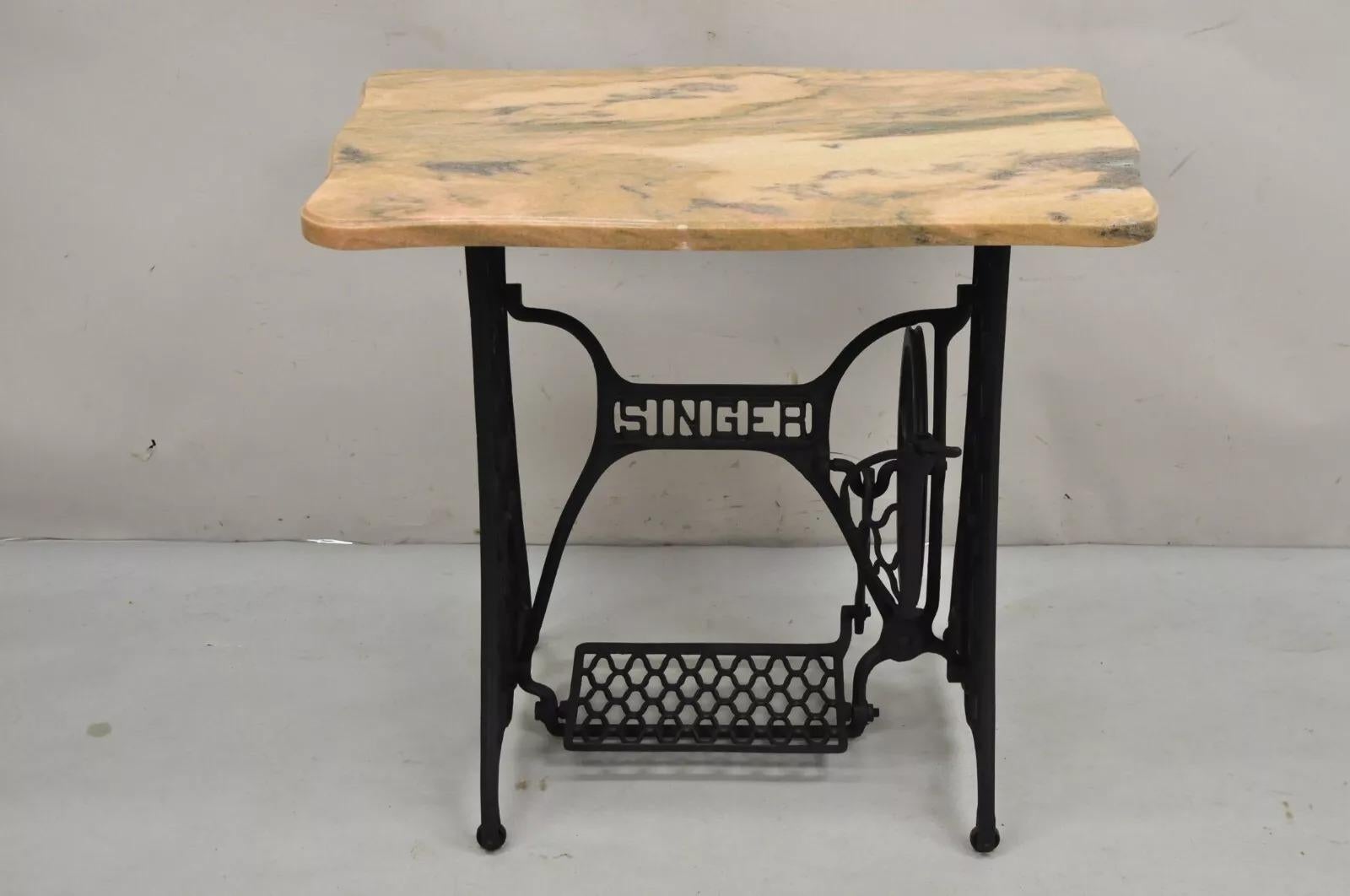 Antique Singer Cast Iron Treadle Sewing Machine Pink Shaped Marble Top Accent Table. Foot pedal and wheel do work. Circa Early 20th Century. Measurements: 29.5