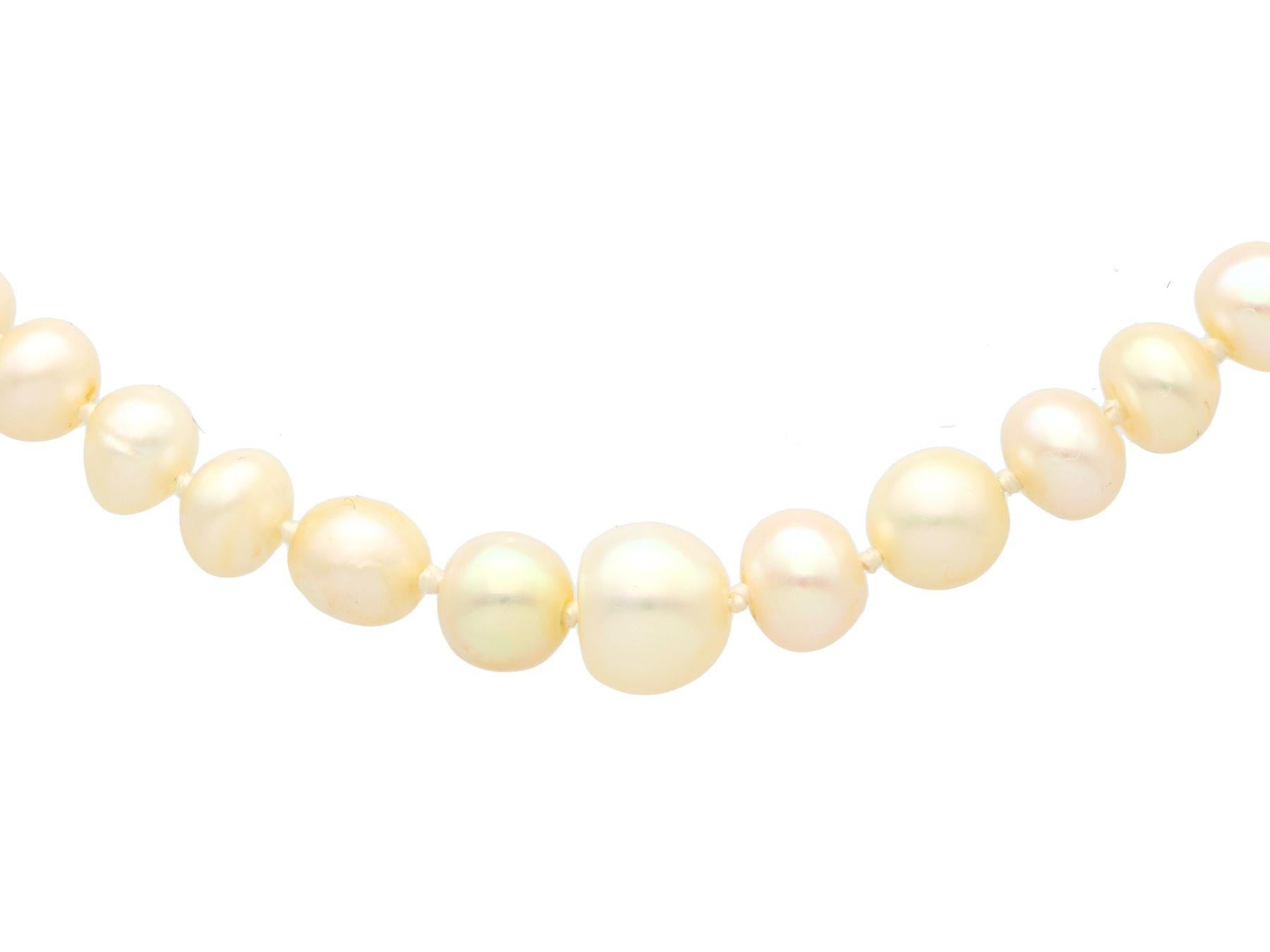 A stunning, fine and impressive single strand natural pearl necklace with a 1.02 carat diamond and silver set clasp; part of our diverse vintage jewellery and estate jewelry collections.

This stunning, fine and impressive antique pearl necklace has