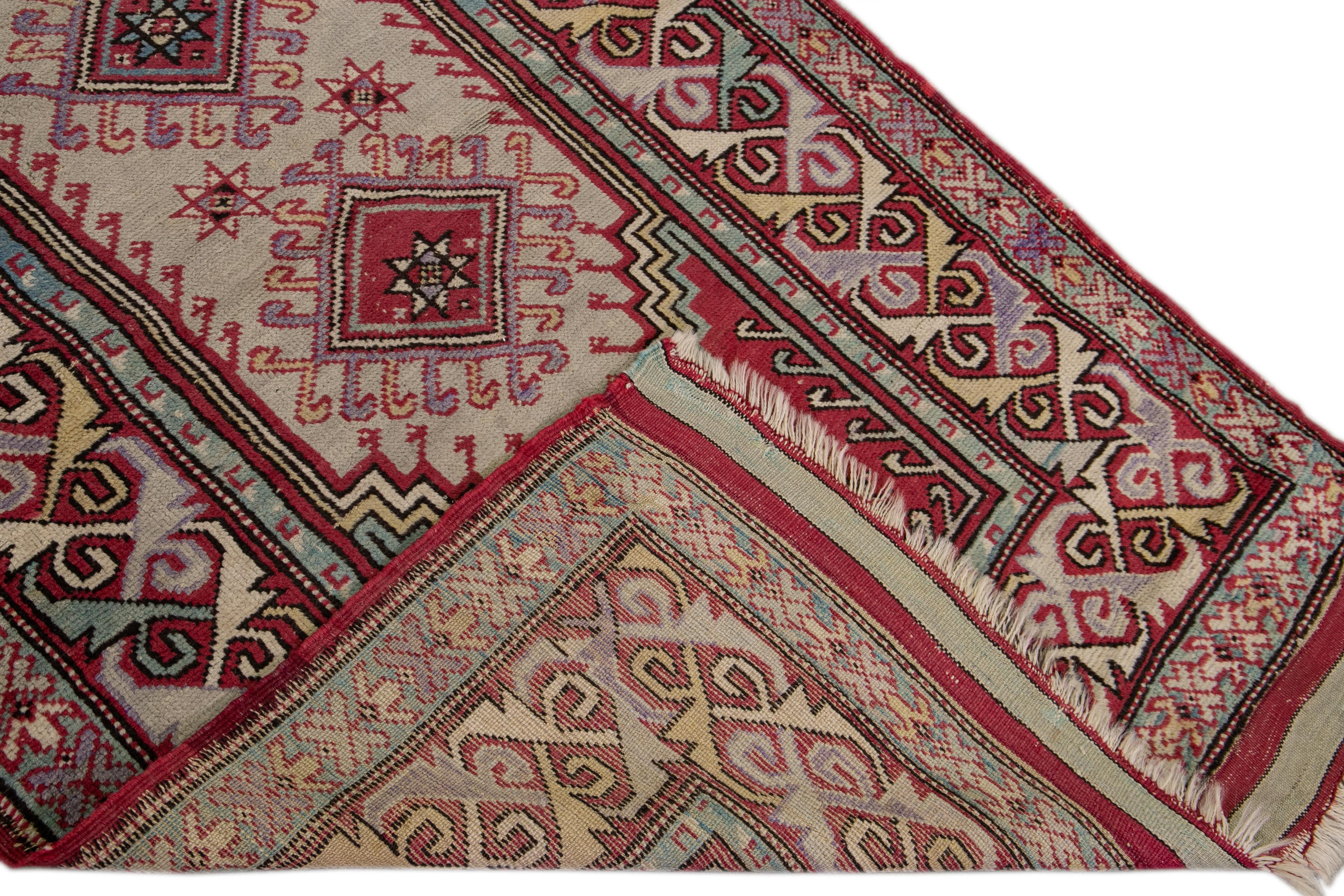 Beautiful Sivas hand-knotted wool rug with a beige field. This piece has red borders and a multicolor accents layout on a geometric design. 

This rug measures: 3'6