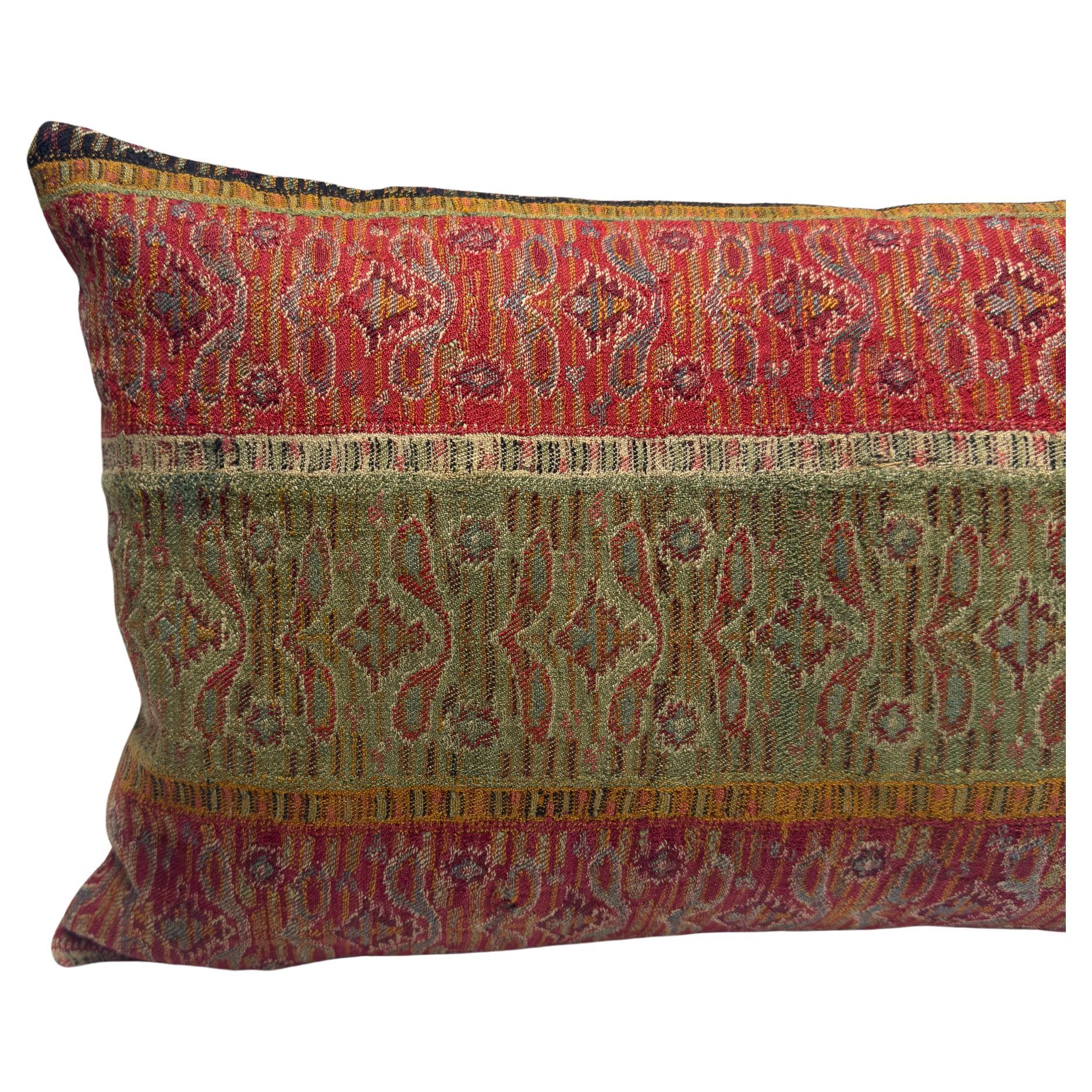 Crafted from antique handwoven wool once used as waistbands in regional women’s attire, this cover offers a rare glimpse into the sartorial traditions of Sivas, an Anatolian region of Turkey. The vertical striping in earthy reds, creams, and deep