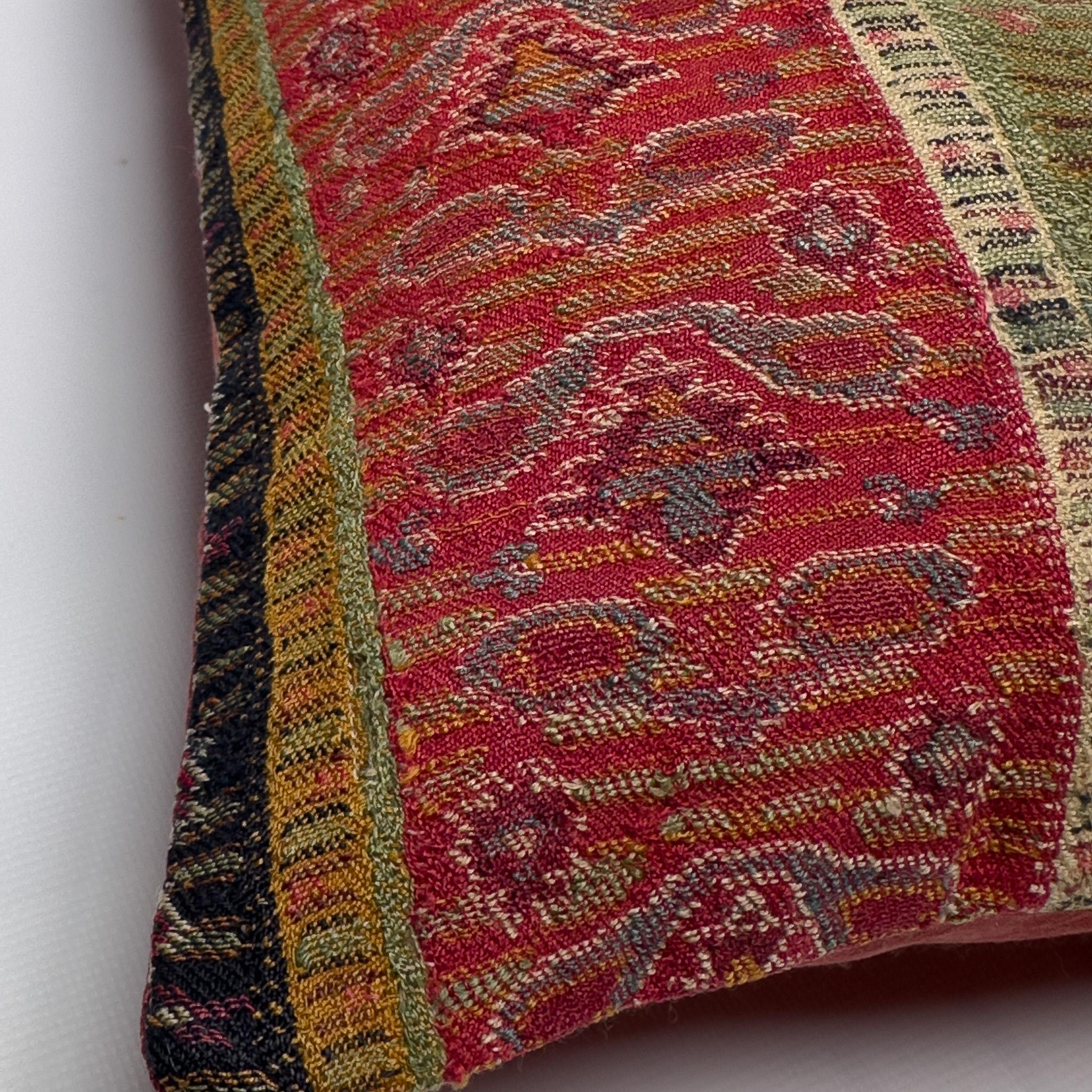 Crafted from antique handwoven wool once used as waistbands in regional women’s attire, this cover offers a rare glimpse into the sartorial traditions of Sivas, an Anatolian region of Turkey. The vertical striping in earthy reds, creams, and deep