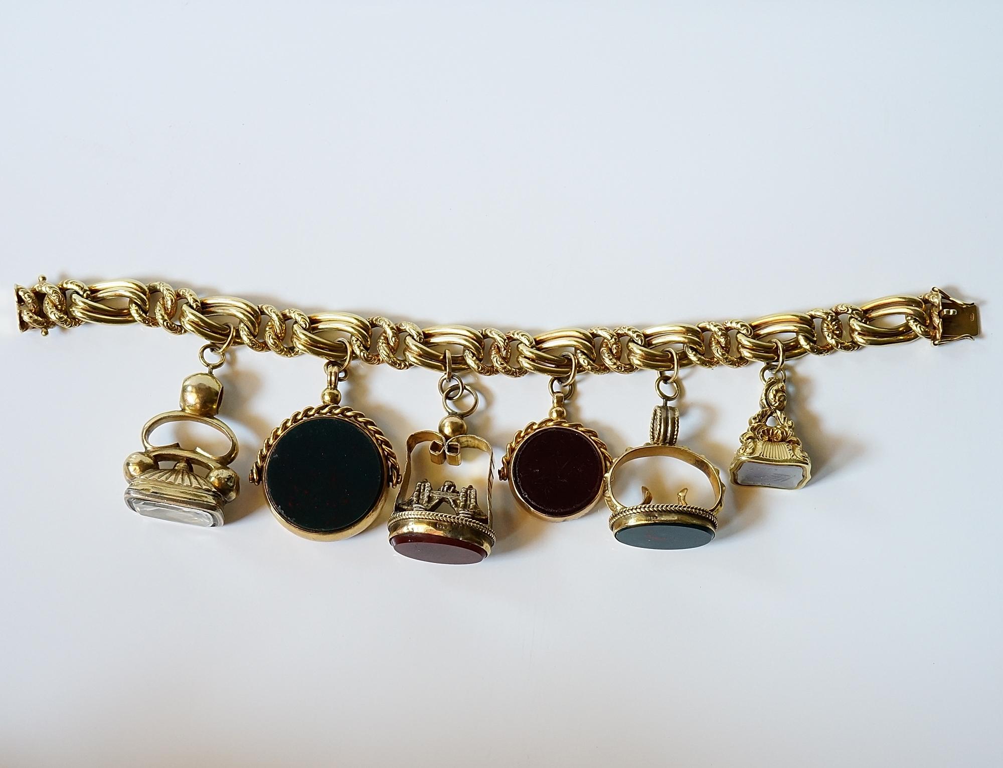 The Old Must!

Large, dramatic, unique, antique, fob charms bracelet hand crafted of solid 14 KT and 9 Kt for two Fobs
Starting from the link bracelet very intricate and different chain bracelet alternating repousse and plain interlaced in between