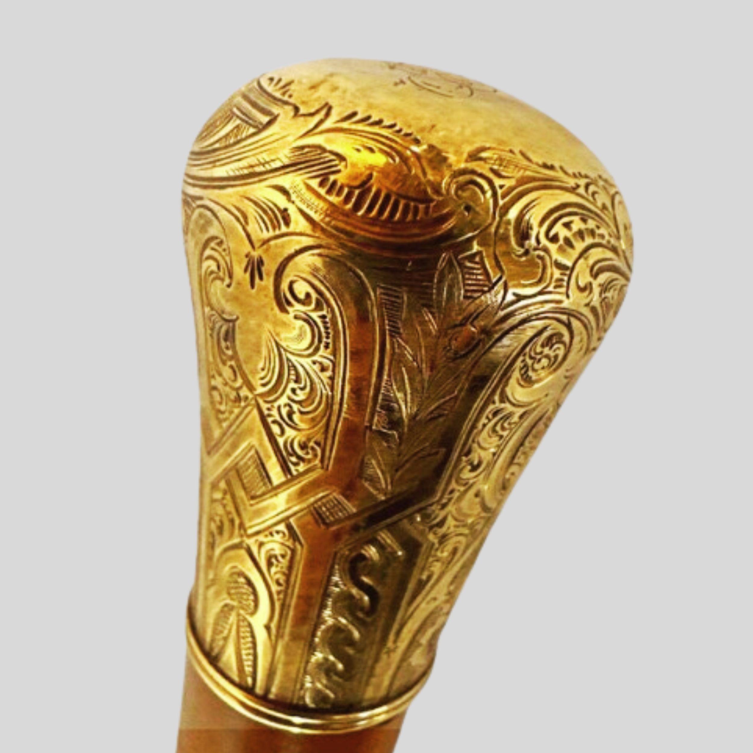 Skinner Gold Plated Knob Handle Antique  Walking Stick Cane Light Brown

This distinctive piece has an intricately carved, gold-plated, knob-style handle affixed atop a gorgeous wooden shaft as rich in color as it is in history. This walking stick /